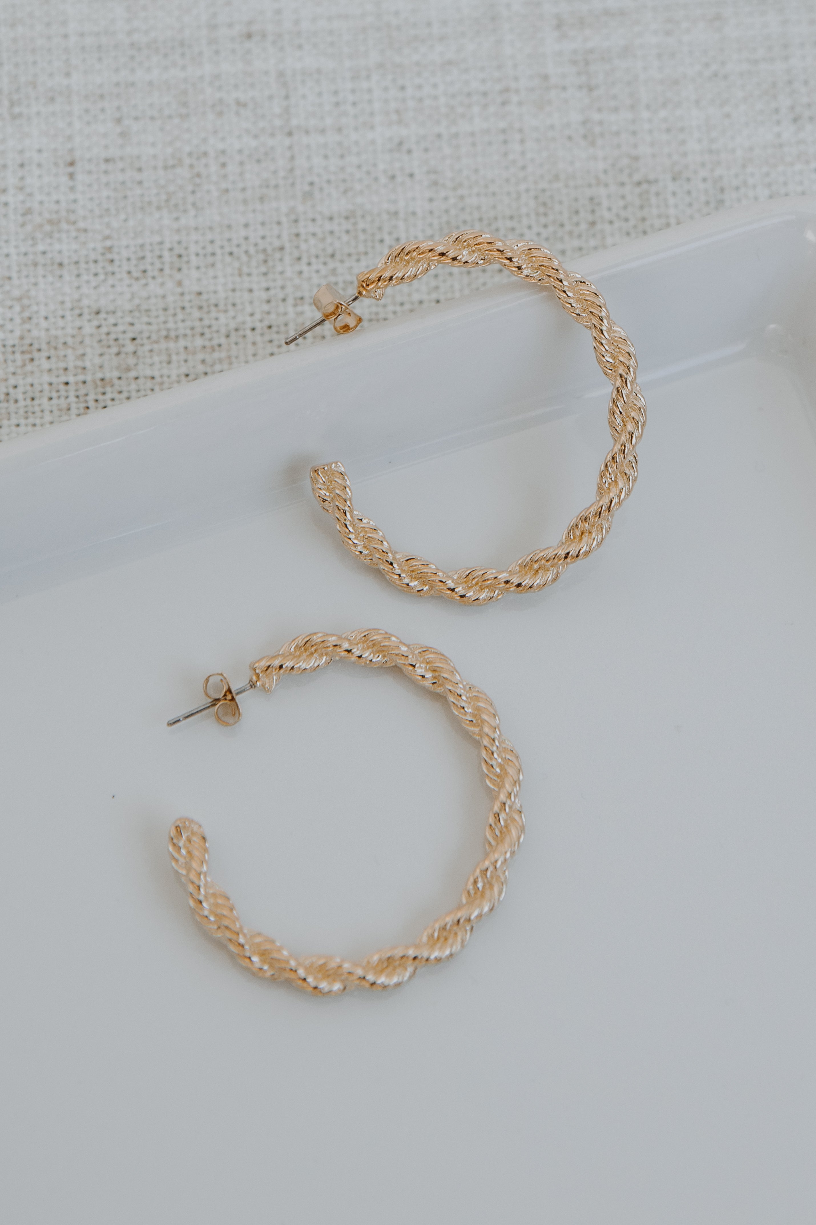 Gold Twisted Hoop Earrings flat lay