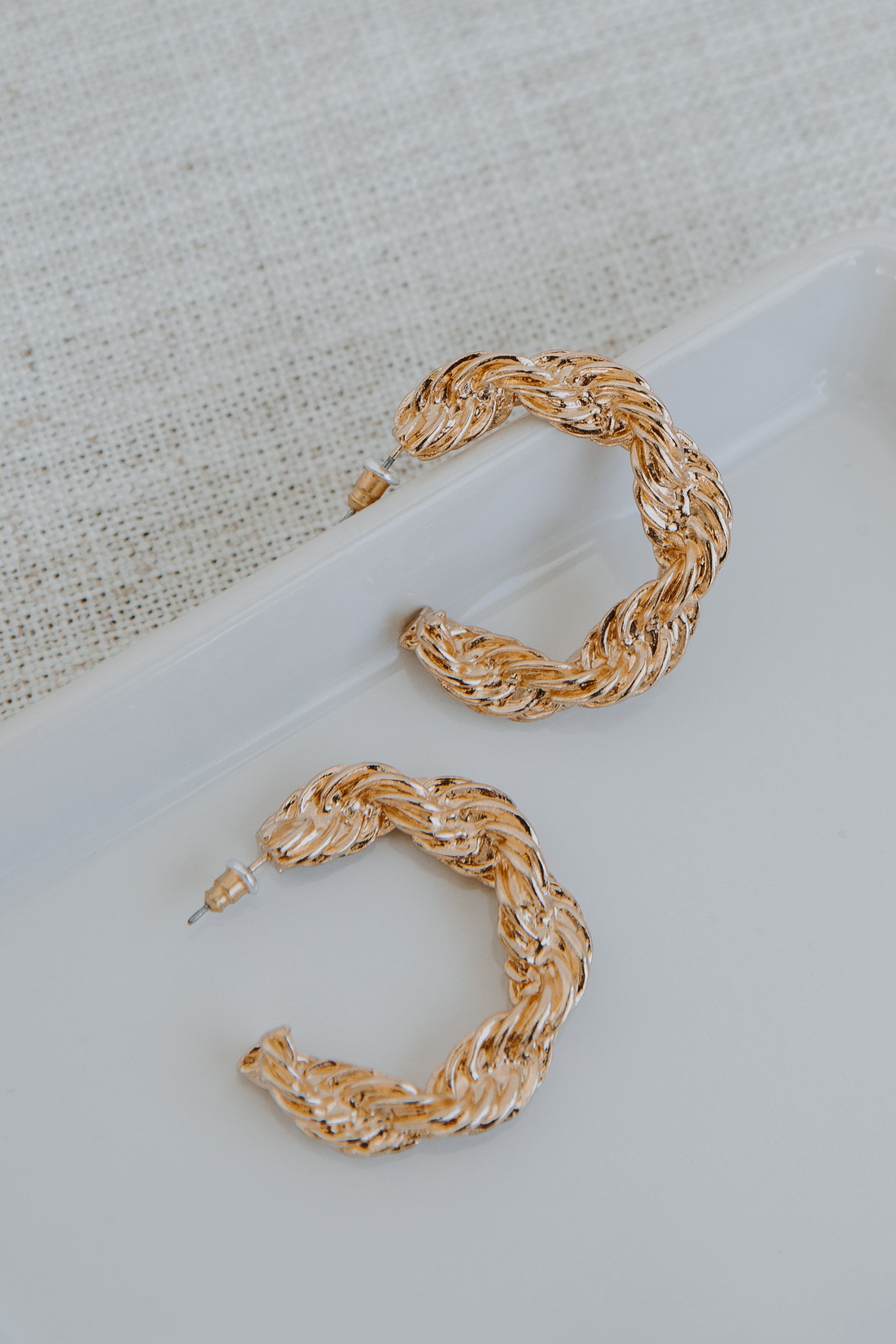 Gold Twisted Hoop Earrings flat lay
