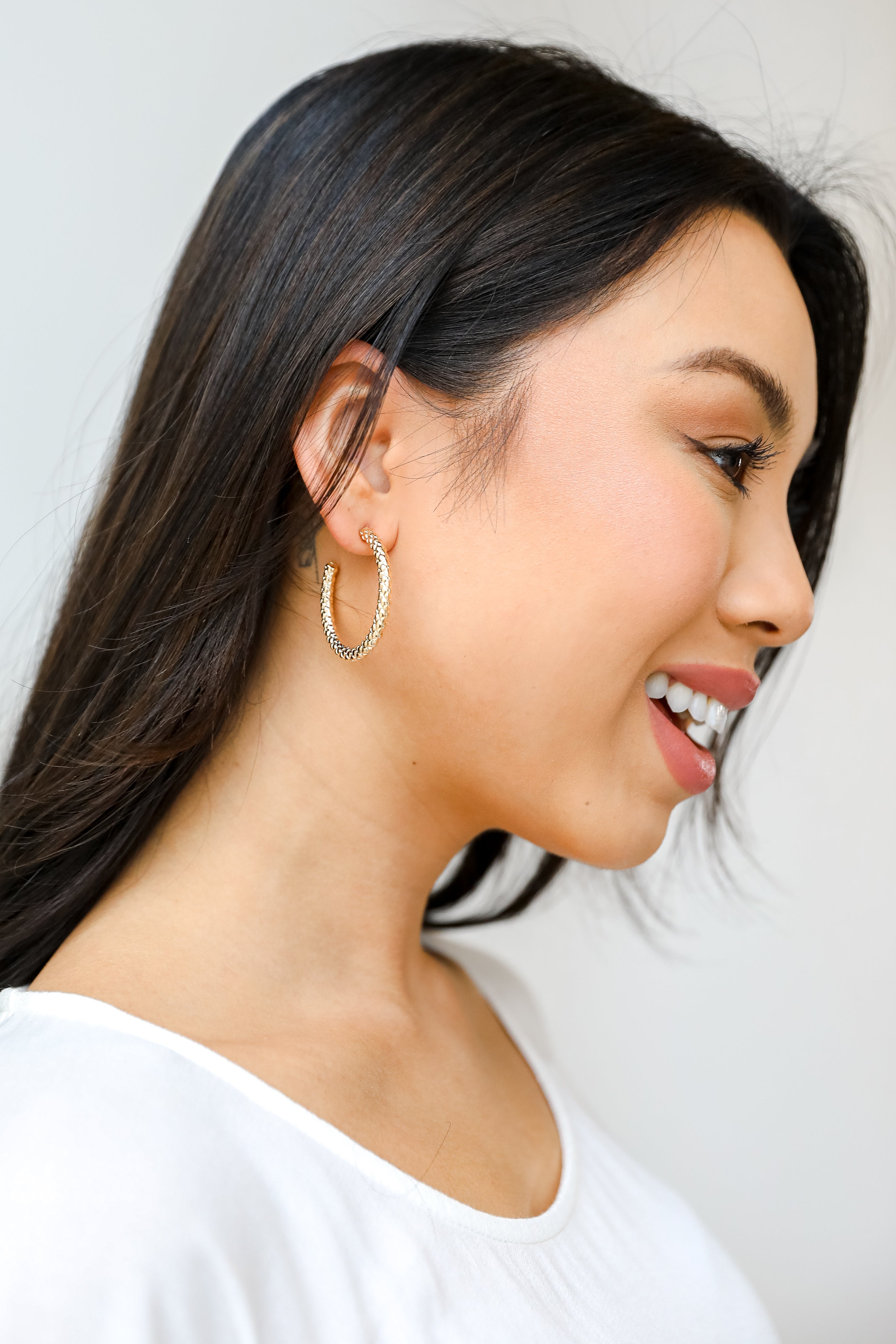 Gold Textured Hoop Earrings on model