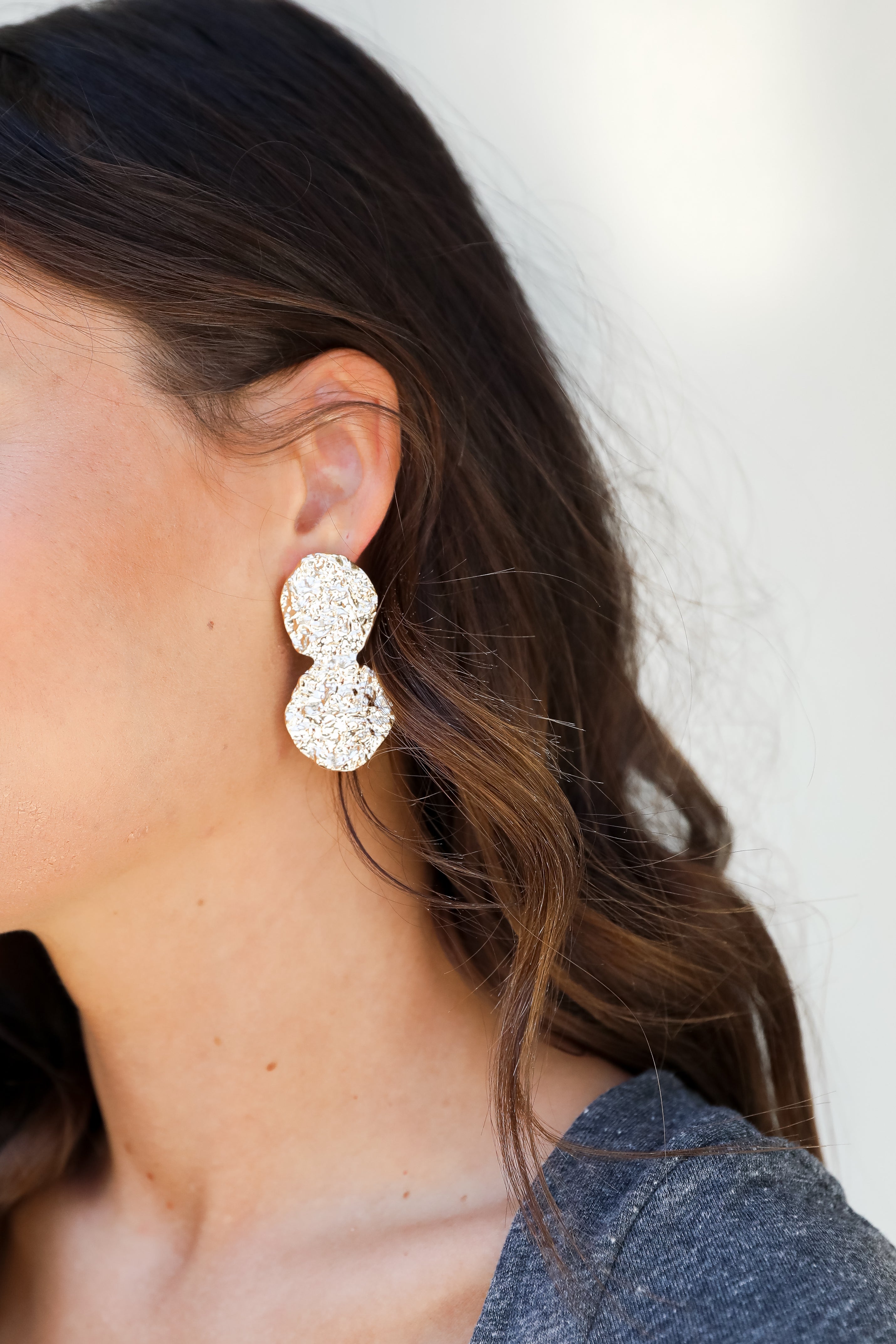 Gold Hammered Drop Earrings on model