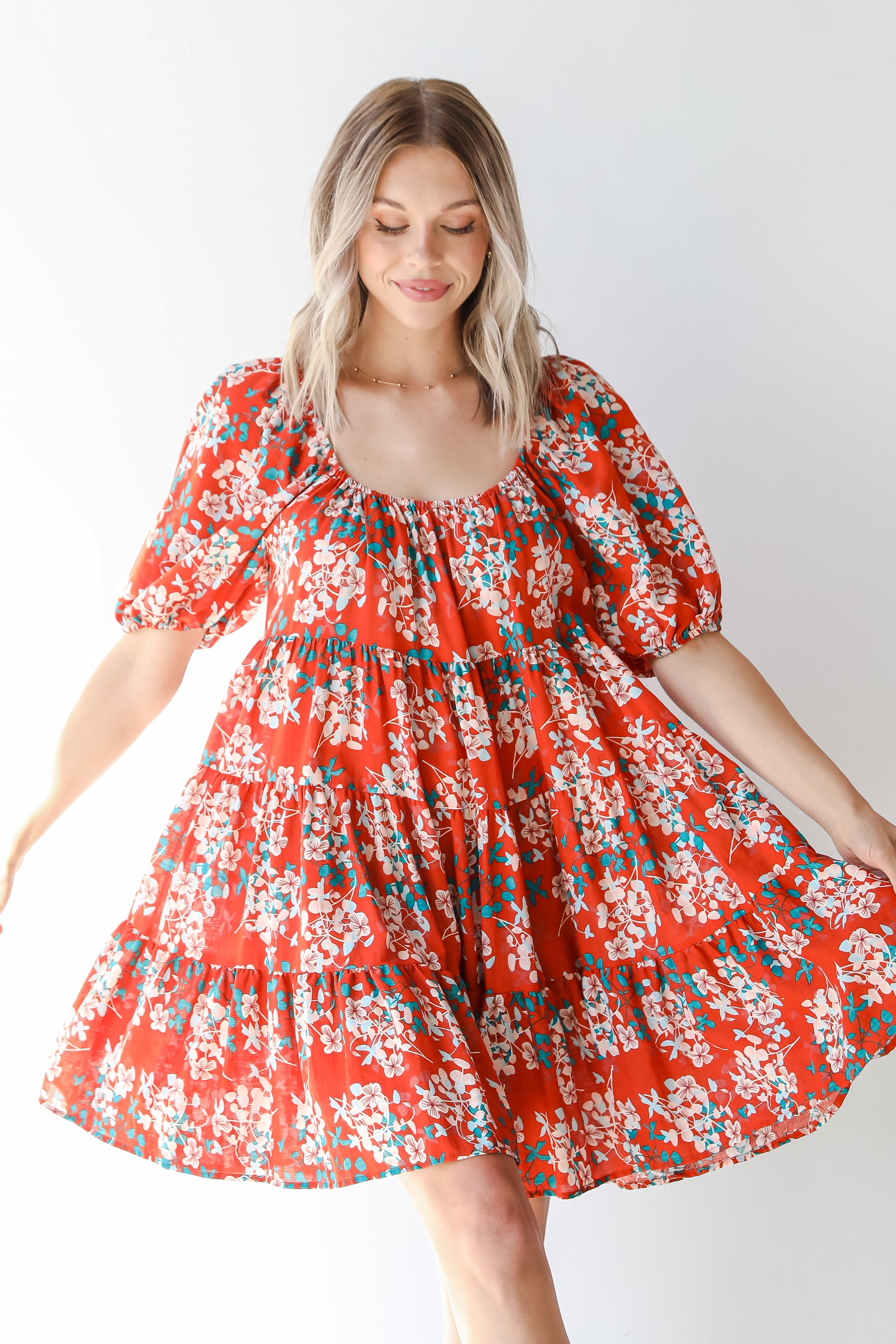 dress up model wearing a rust floral mini dress