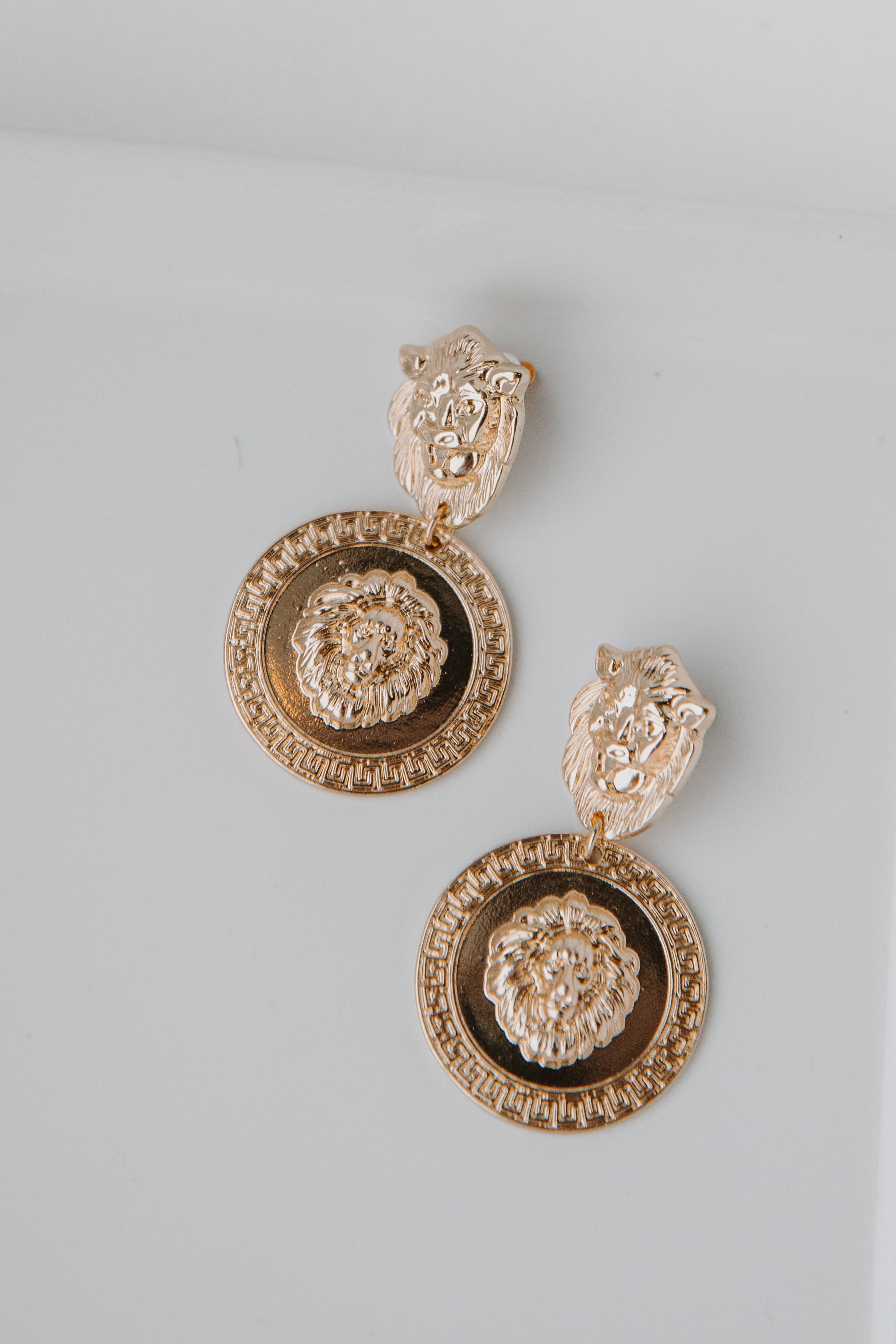 Gold Lion Drop Earrings flat lay