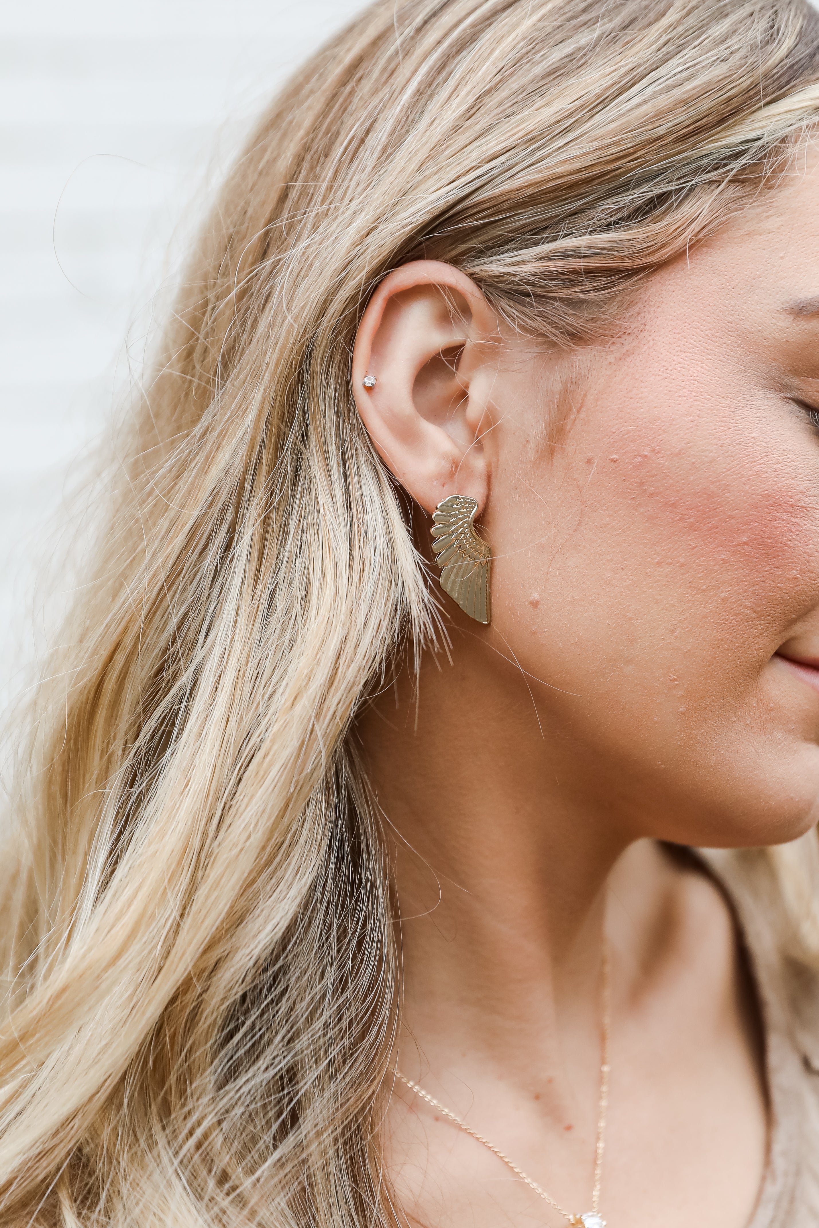Gold Wing Earrings on model