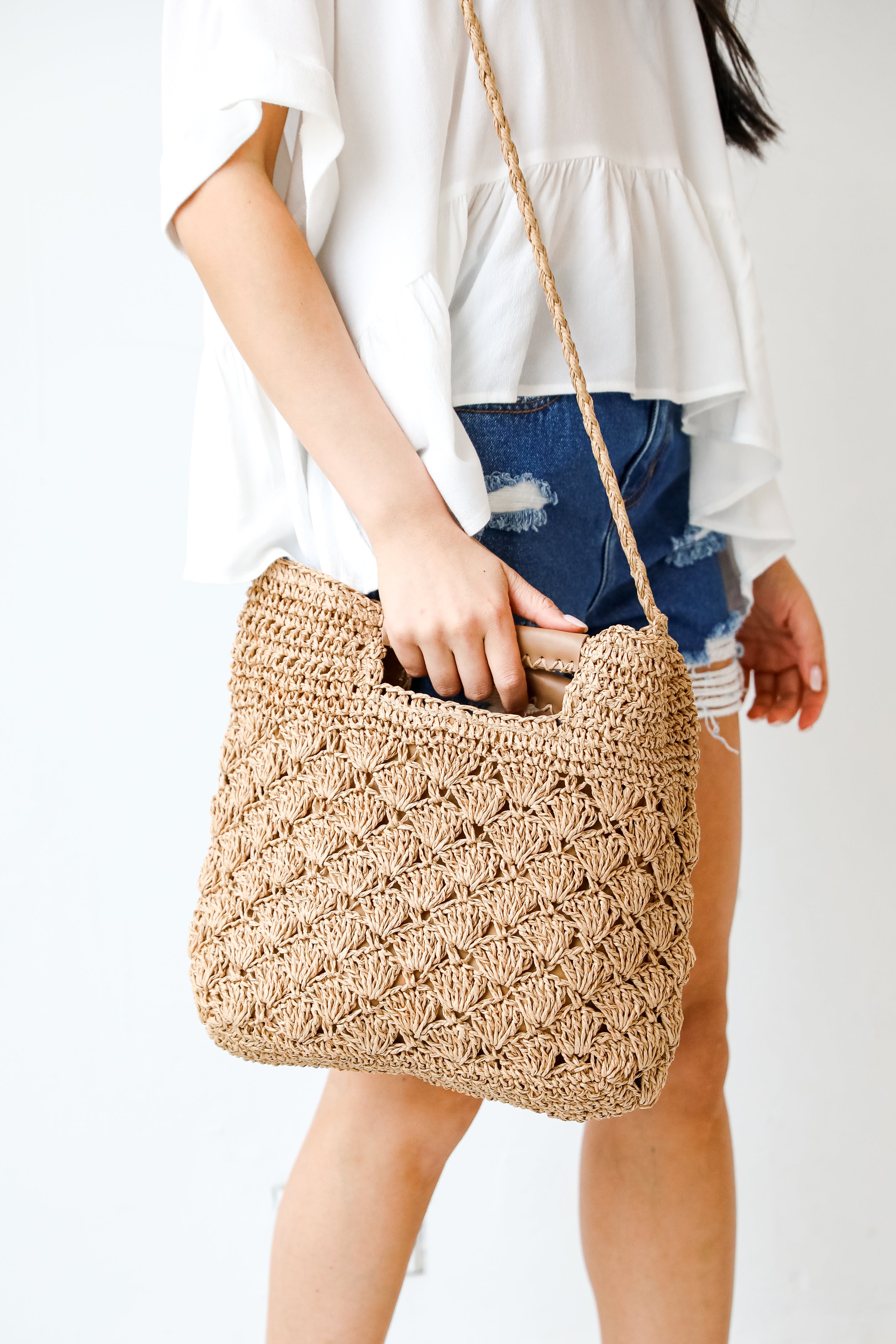 model holding a Straw Crossbody Bag