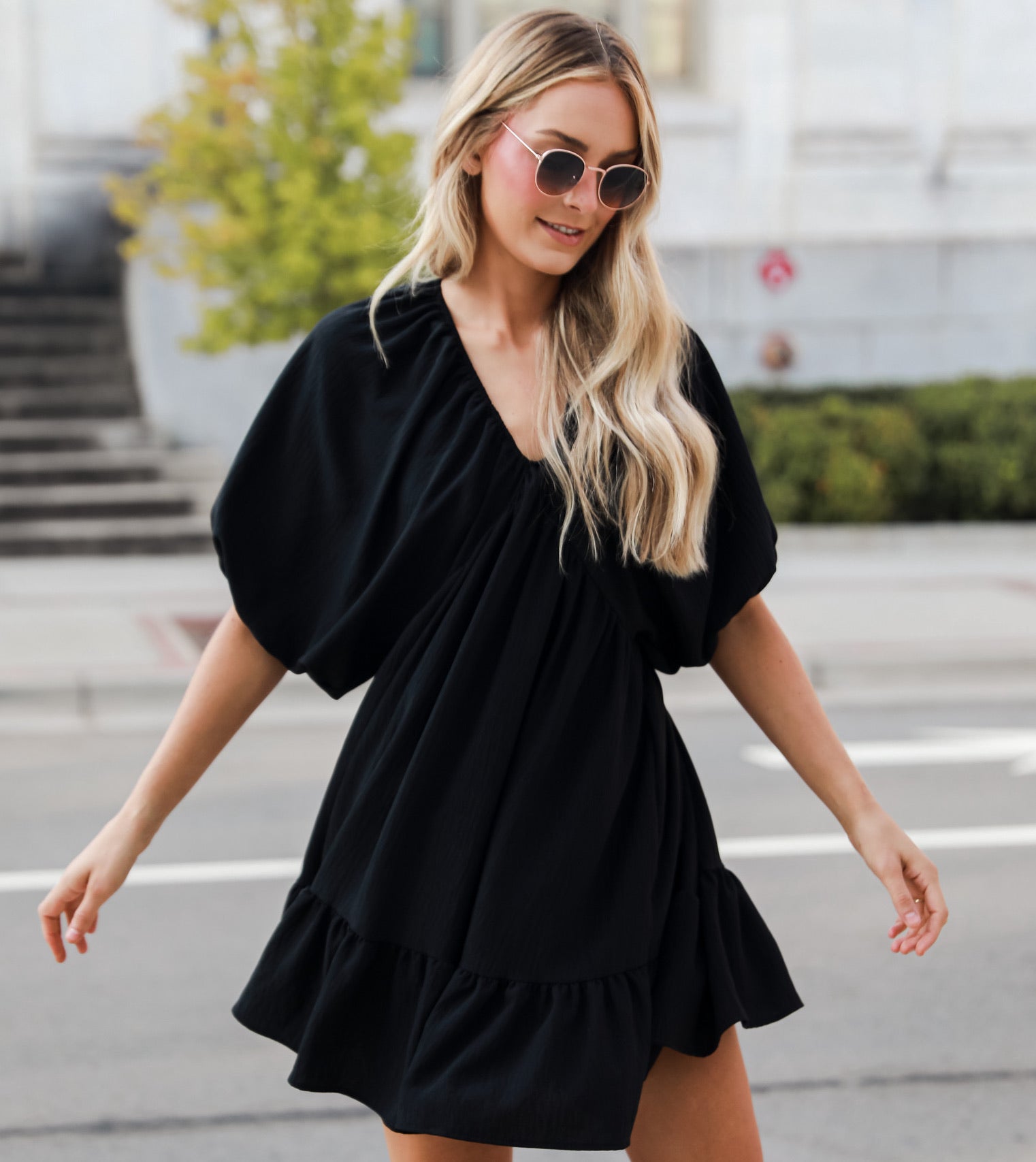 model wearing a black babydoll mini dress