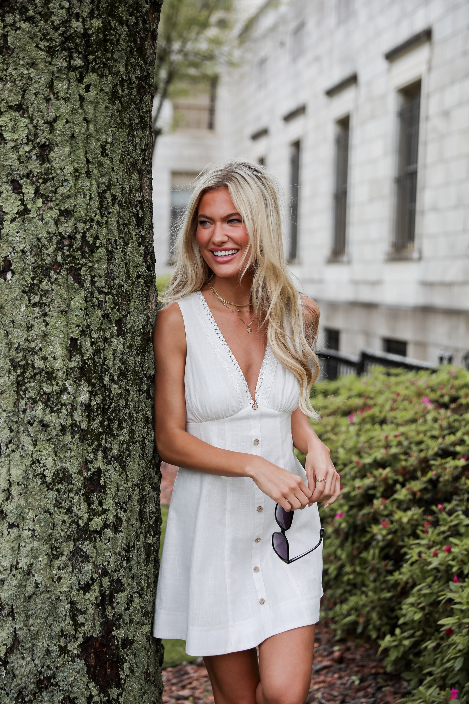 model wearing a cute white mini graduation dress