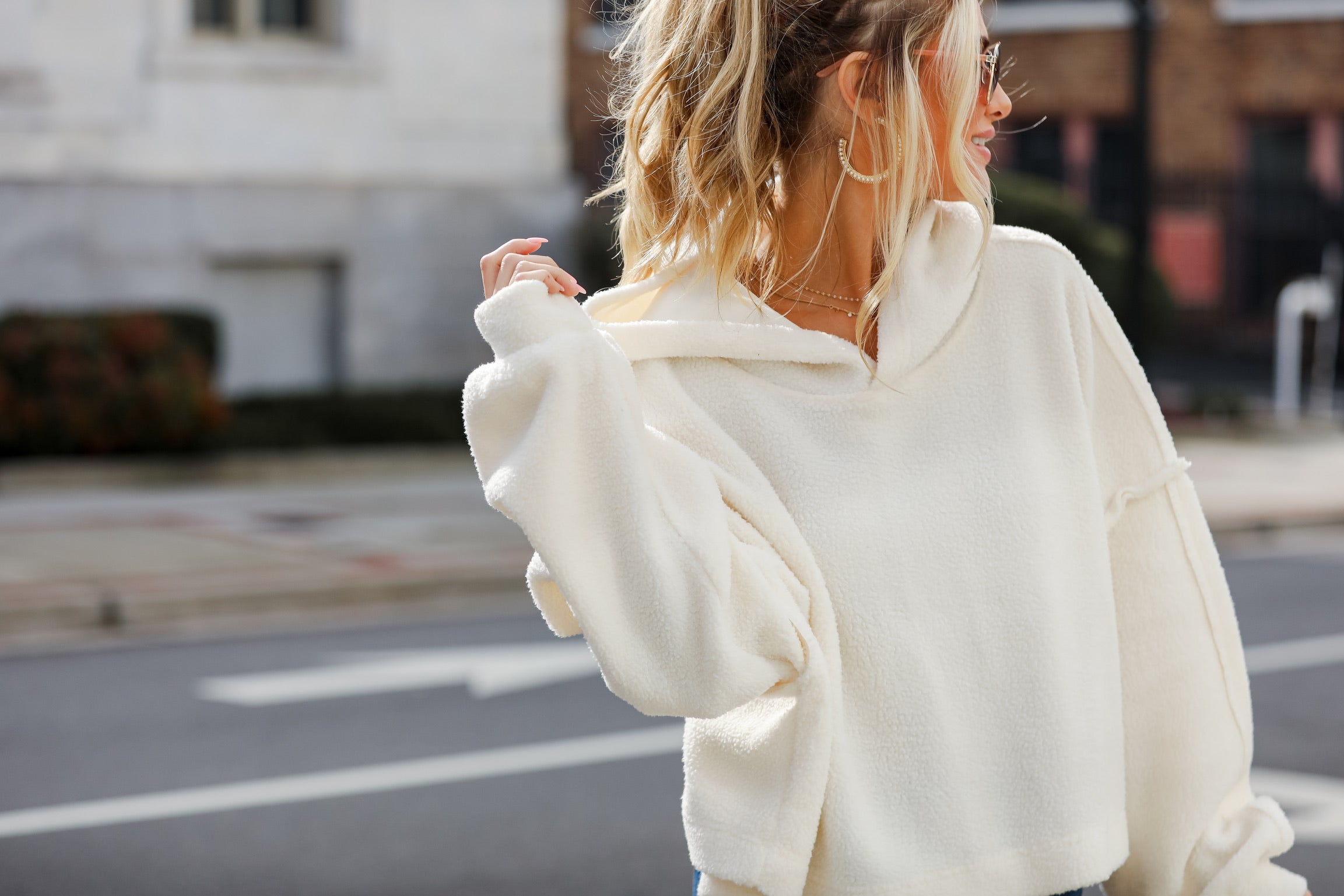 model wearing a cozy white sherpa hoodie