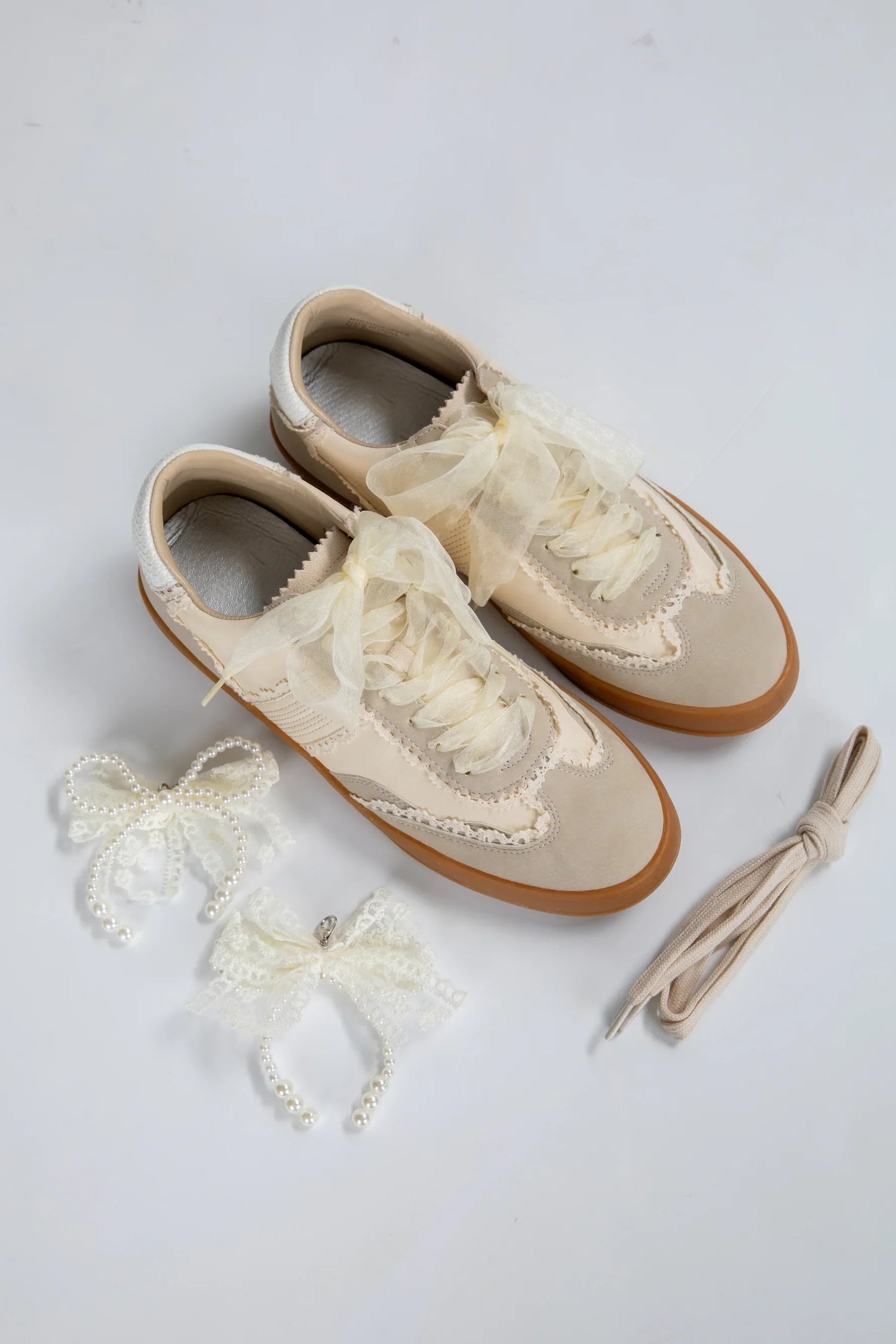 white sneakers with lace and bows. sandals. tennishoes. heels. wedges. boots.