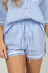 Blue and white striped shirt and shorts set on a neutral background