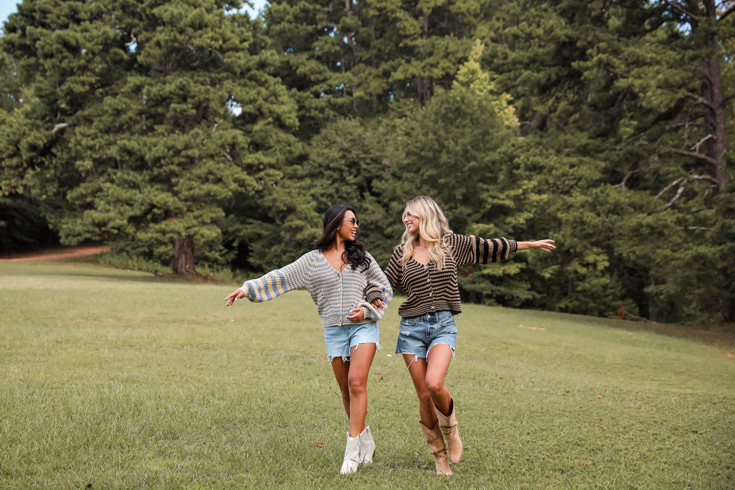 models wearing striped knit sweater cardigans and denim shorts with fall boots