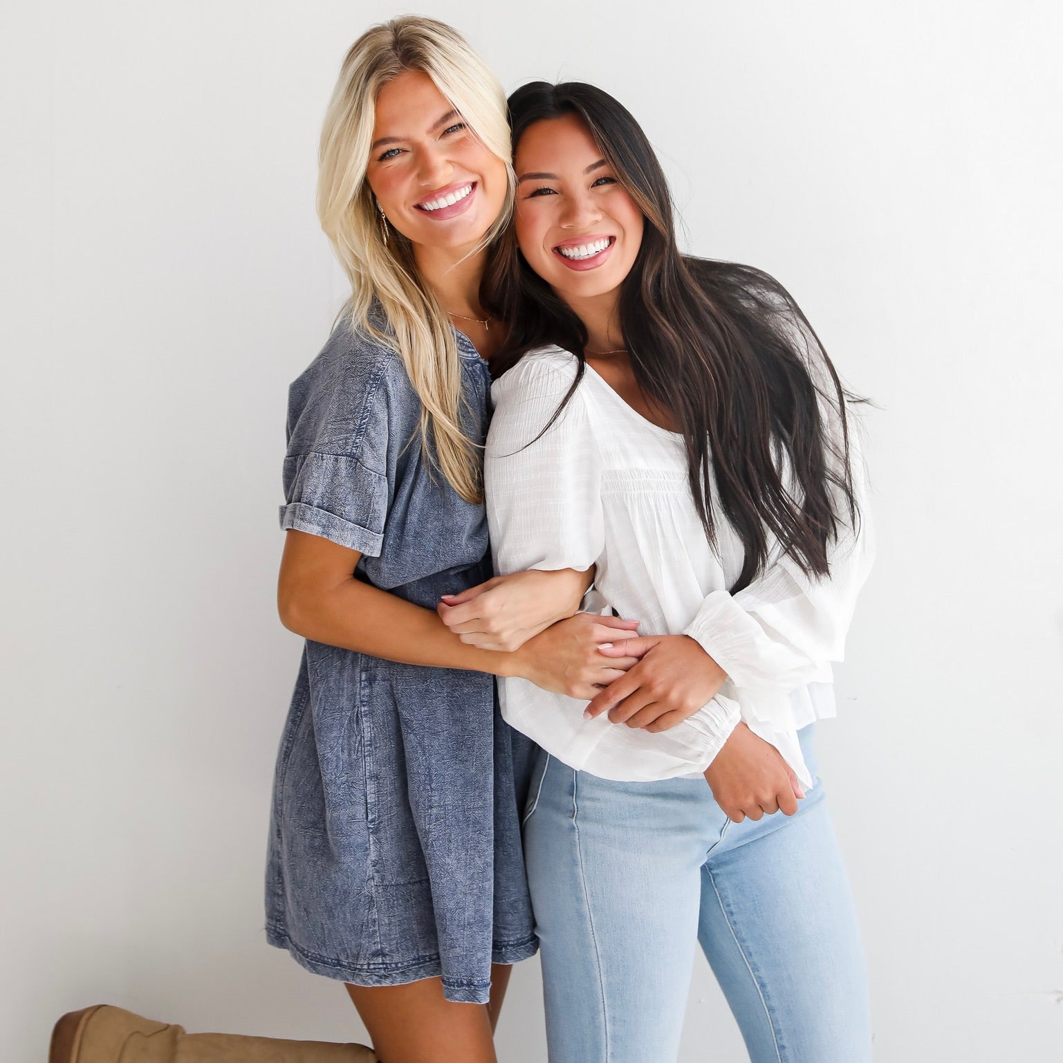 MODEL WEARING DENIM MINI DRESS AND MODEL WEARING WHITE LINEN LONG SLEEVE BLOUSE