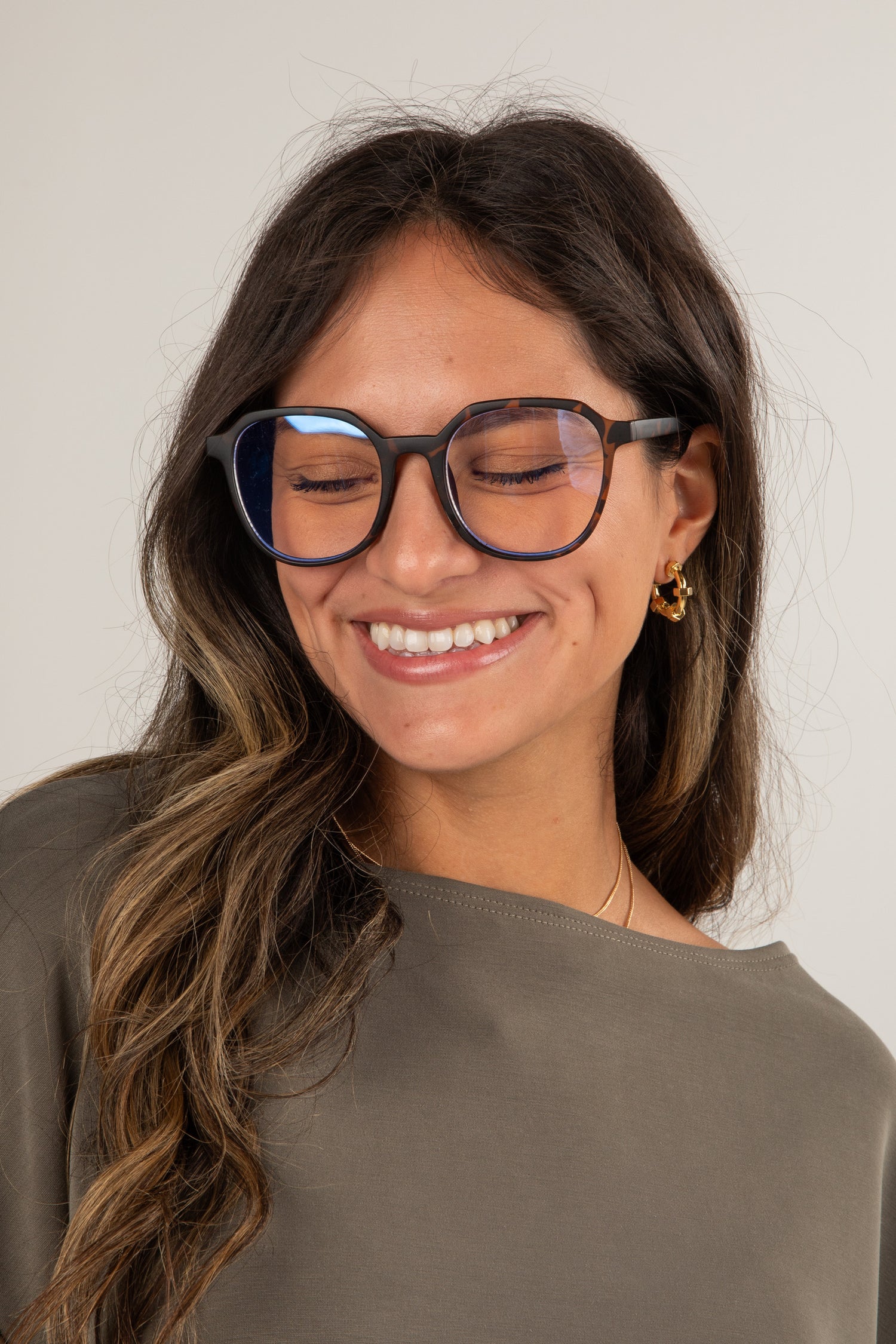 Woman wearing glasses with a neutral background