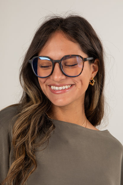Woman wearing glasses with a neutral background