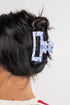 Blue and white marbled hair clip in a person&