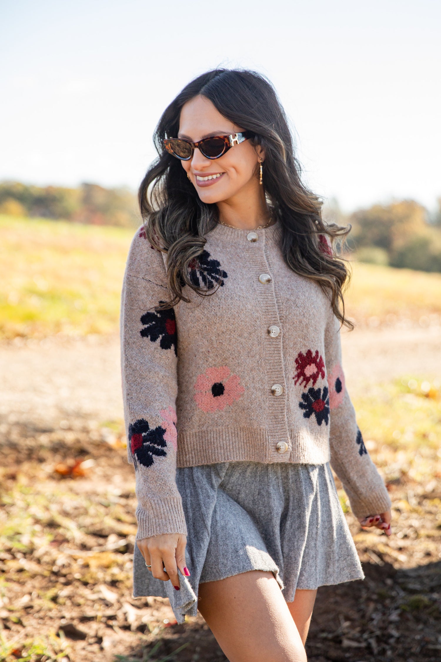 Woman wearing a floral-patterned sweater in an outdoor setting