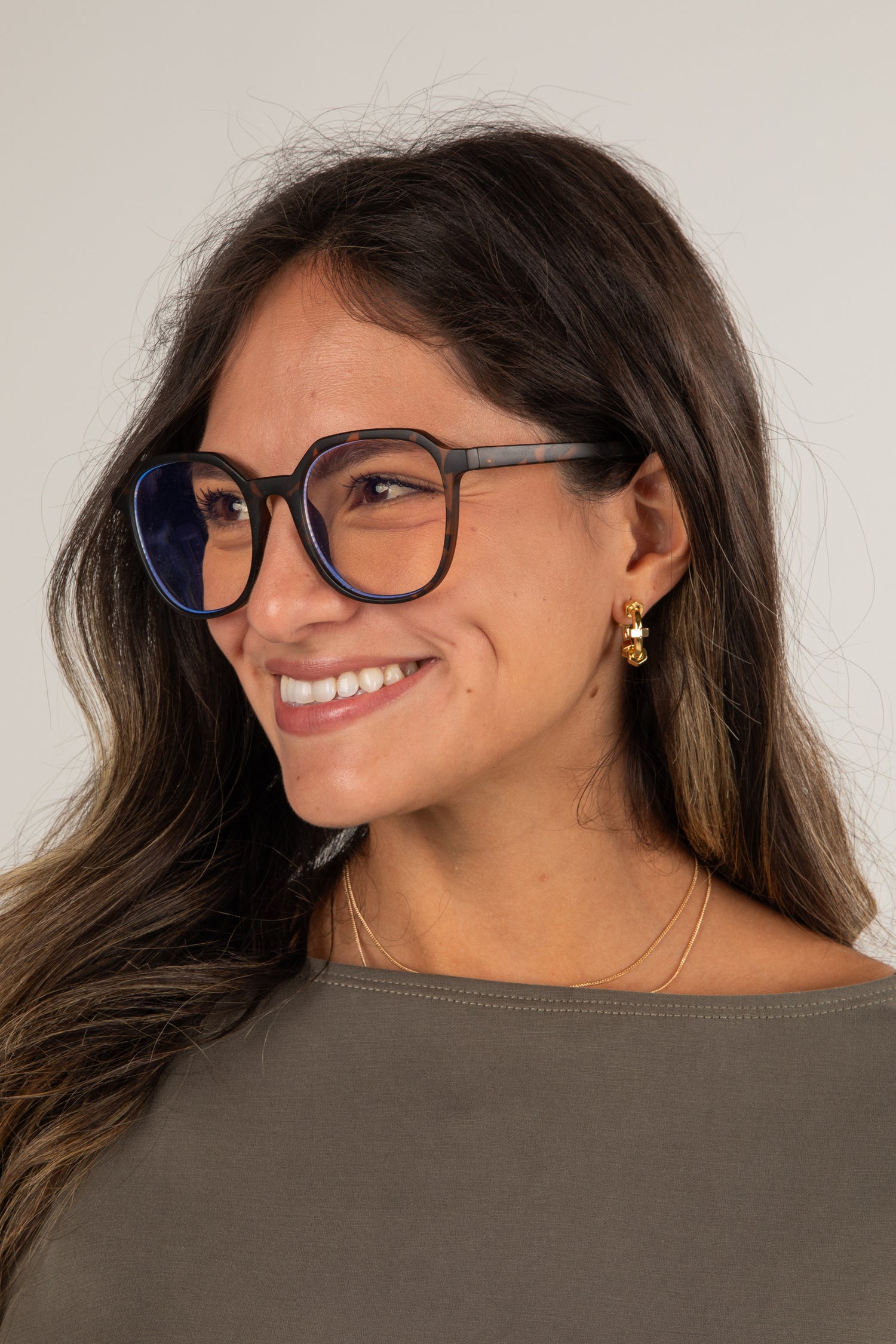 Woman wearing glasses with a neutral background
