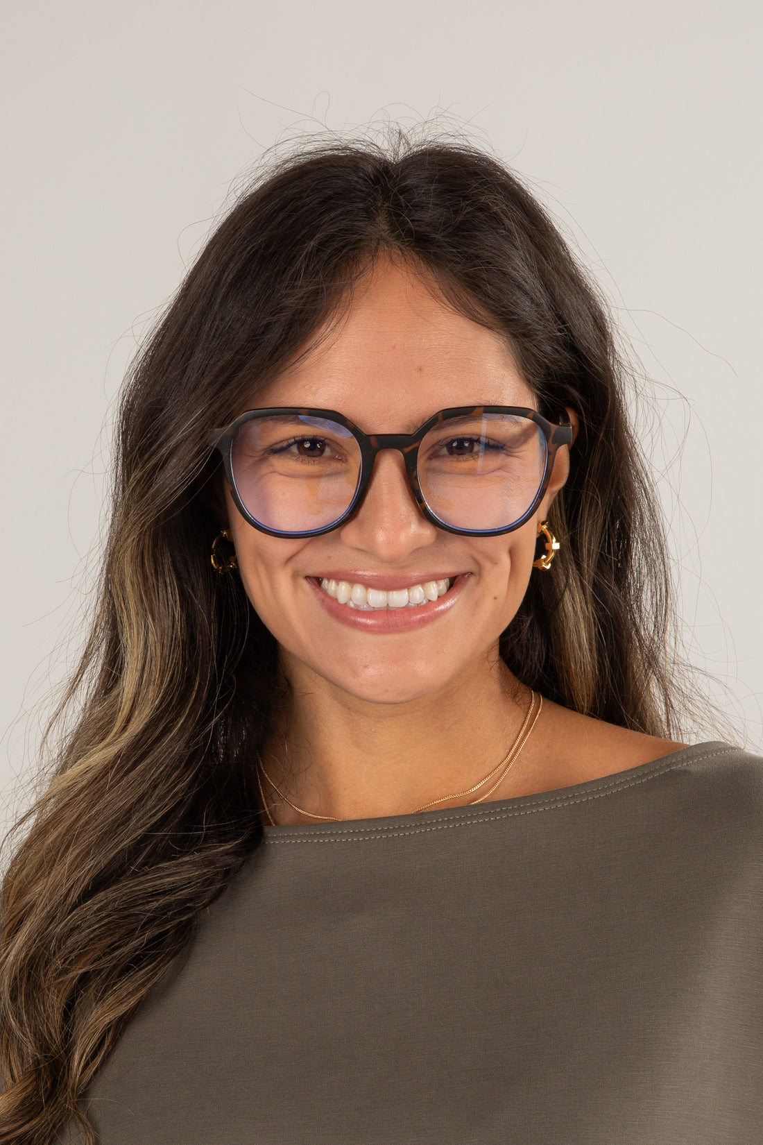 Woman wearing glasses with a plain background
