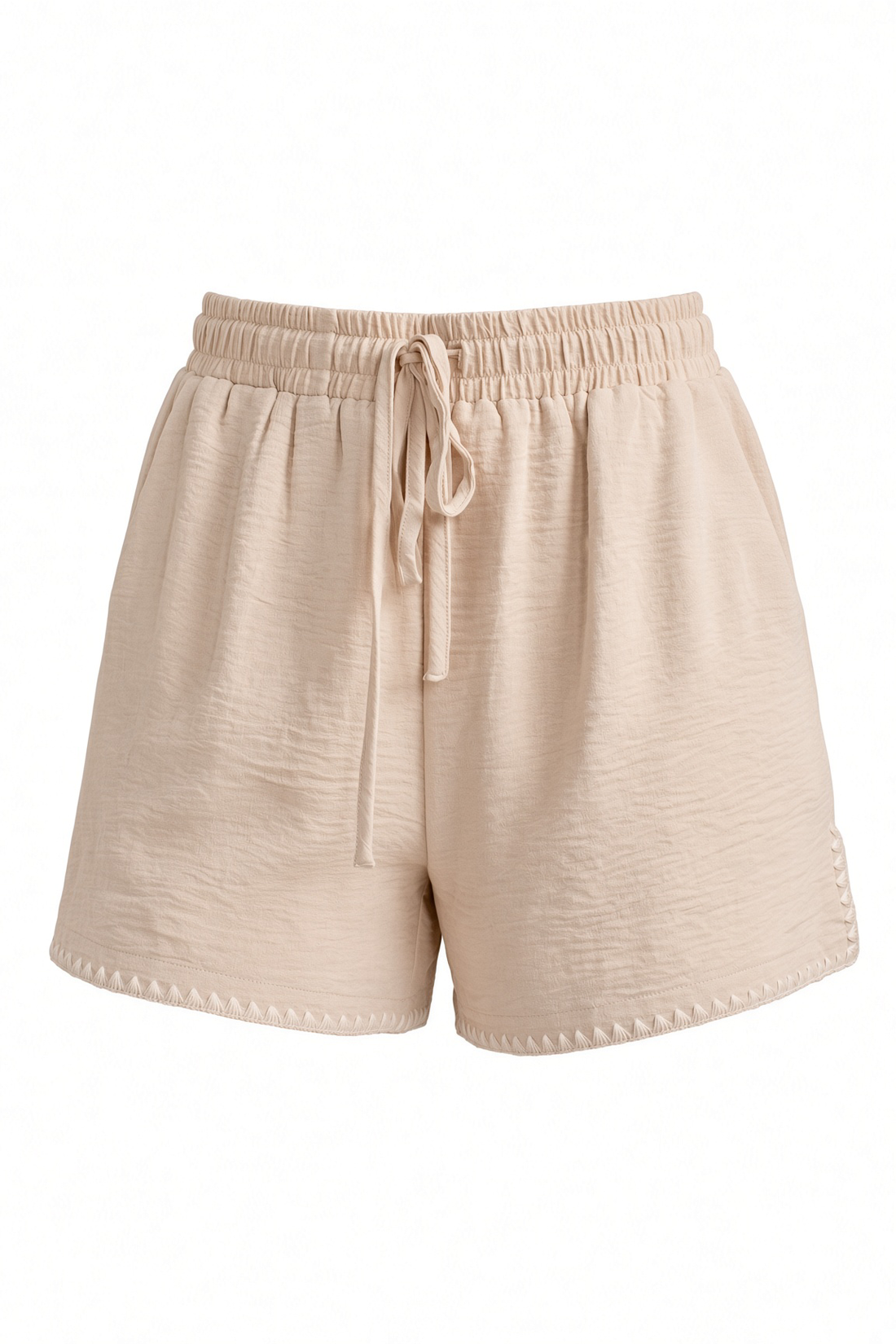 Beige textured drawstring shorts with an elastic waistband, photographed against a plain white background.