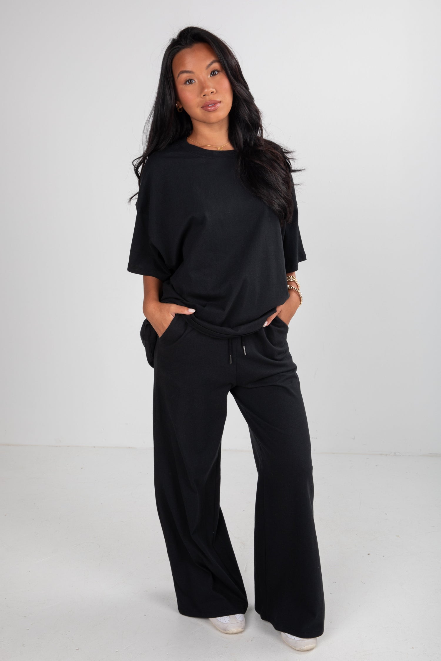 Woman wearing a black outfit on a white background