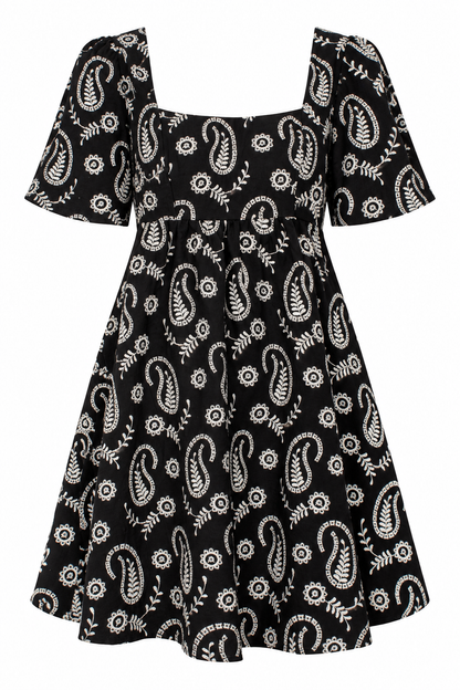 A black short-sleeve dress with a white paisley and floral block print, featuring a square neckline and a flared skirt.