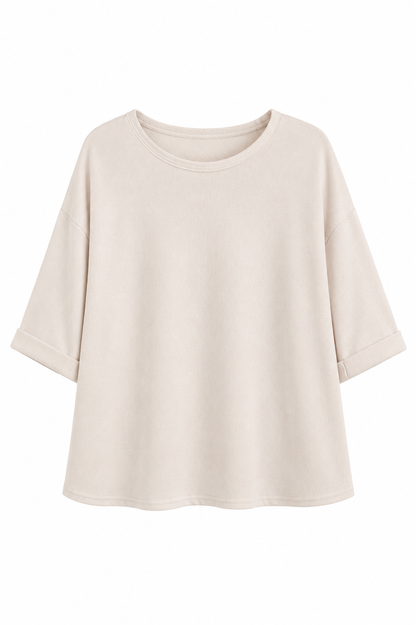 A light beige short-sleeve crewneck top with a relaxed, oversized fit and rolled cuffs, shown against a plain white background.