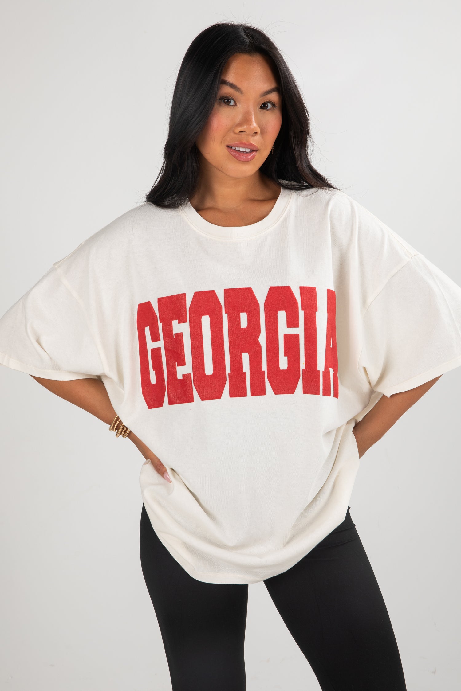 Woman wearing a white oversized t-shirt with &