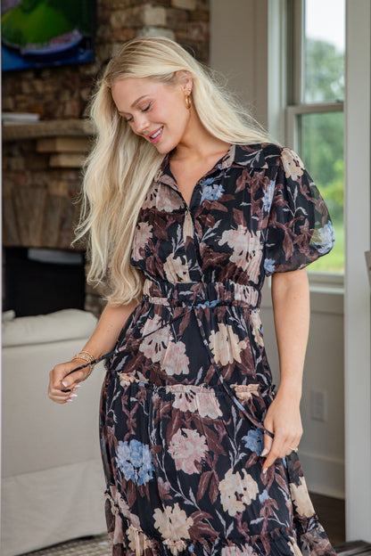 Woman wearing a floral dress in a home setting