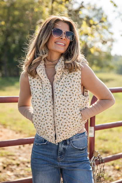 Woman wearing a patterned vest and sunglasses outdoors