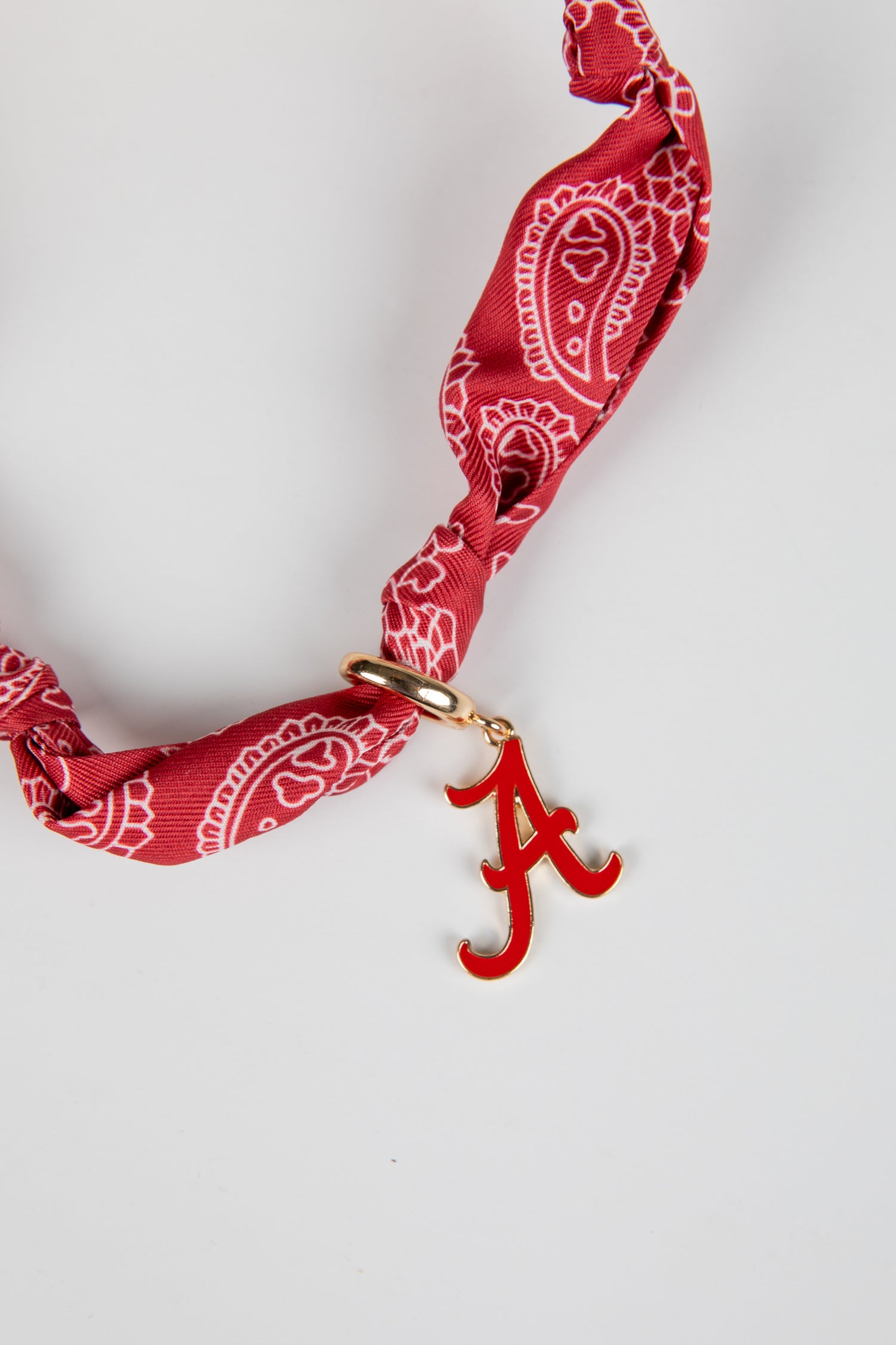 Red bandana with a gold clasp and red &