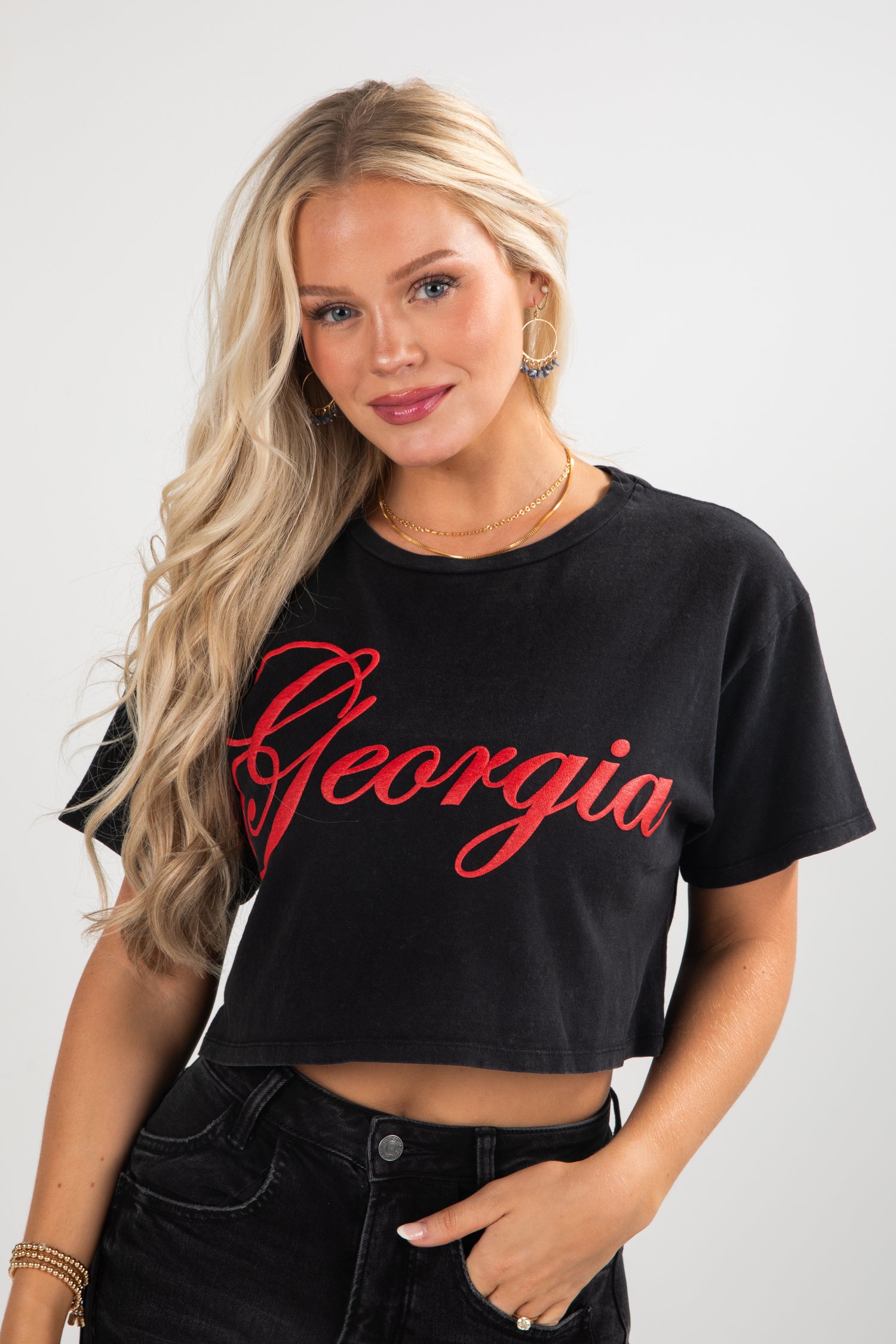 Woman wearing a black crop top with &