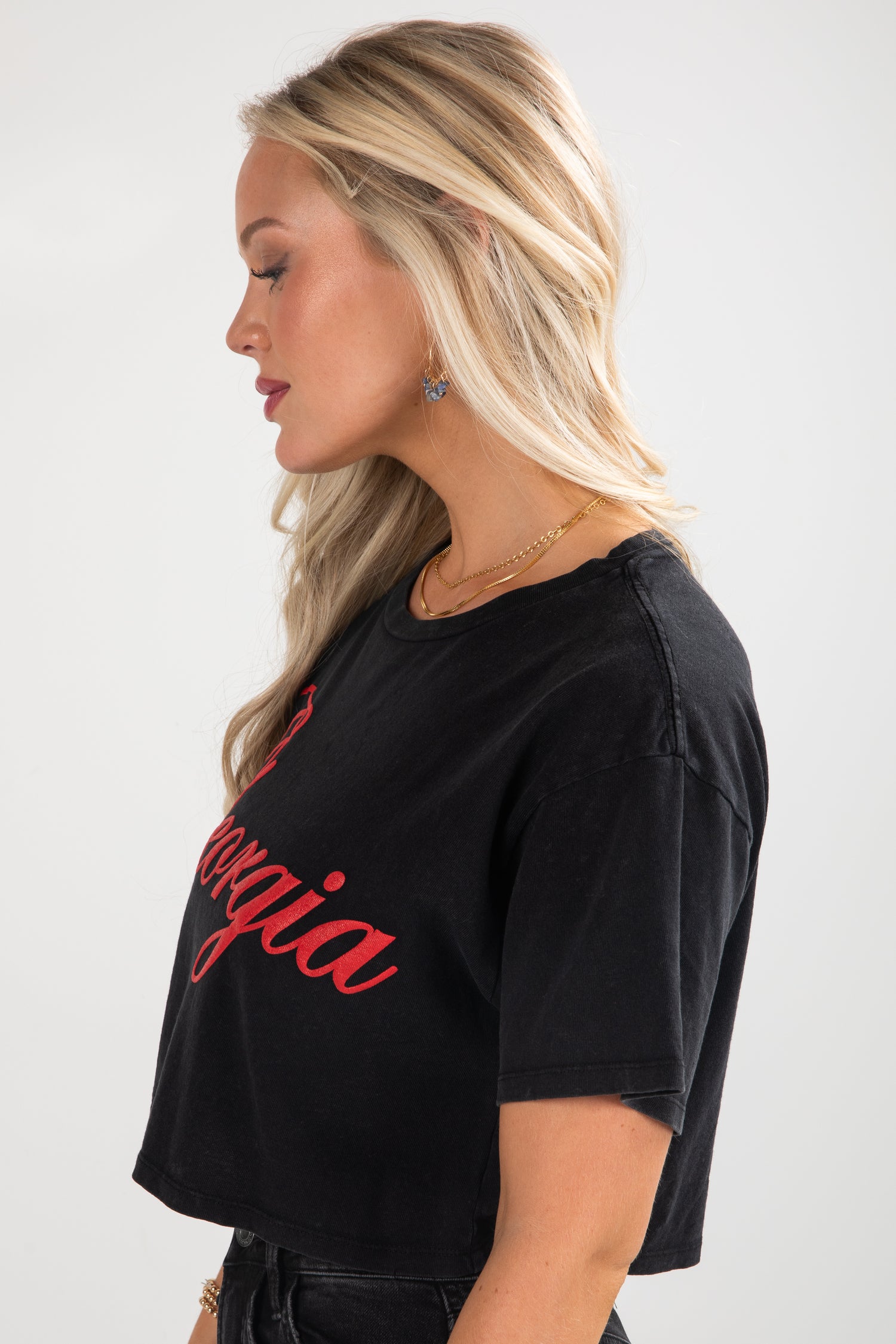 Woman wearing a black t-shirt with red text on a white background