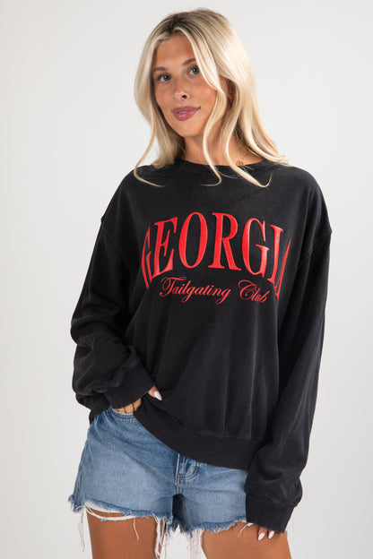 Woman wearing a black sweatshirt with &