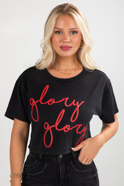 Woman wearing a black t-shirt with red text &