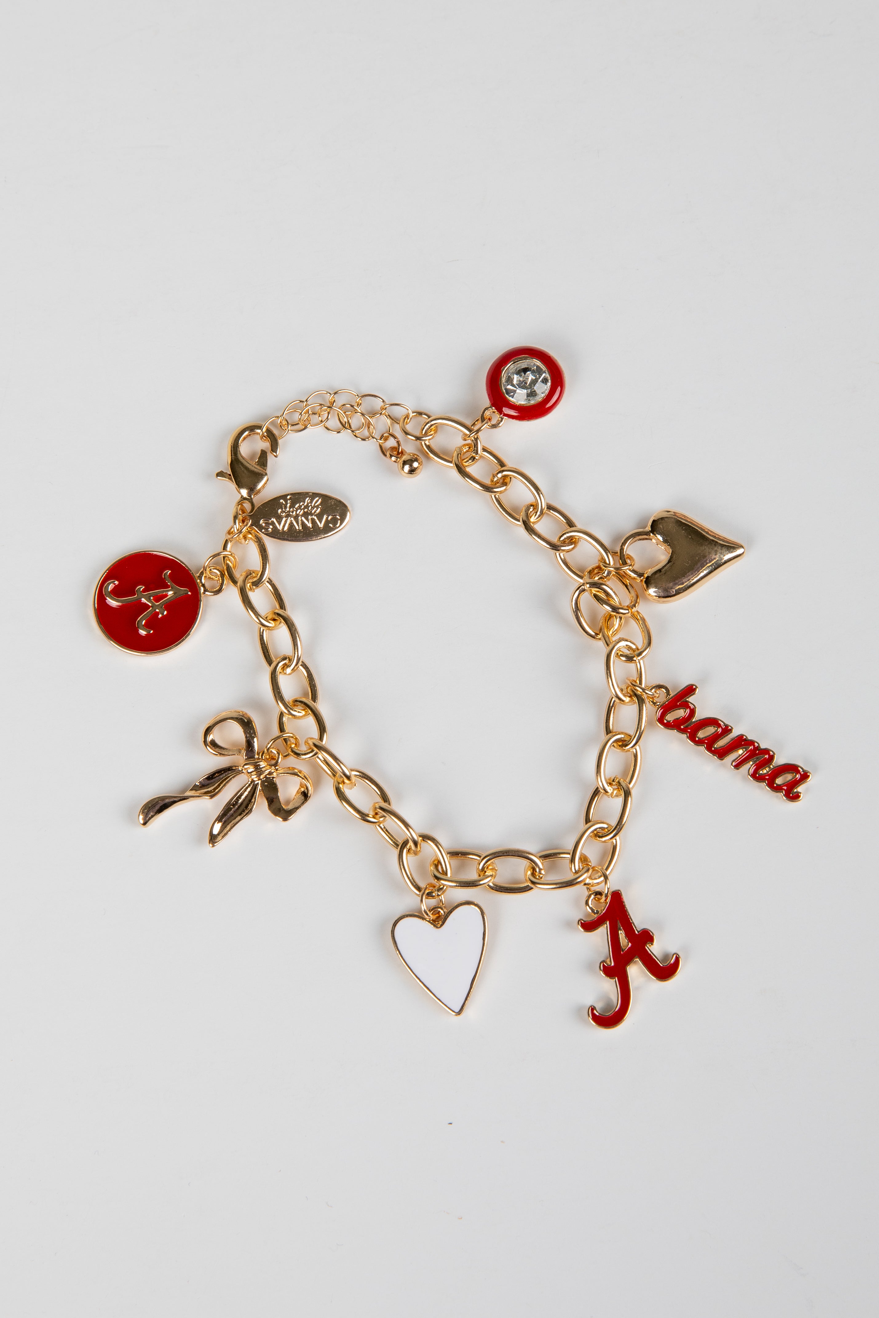 Gold charm bracelet with various charms on a white background