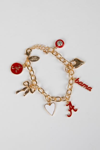 Gold charm bracelet with various charms on a white background