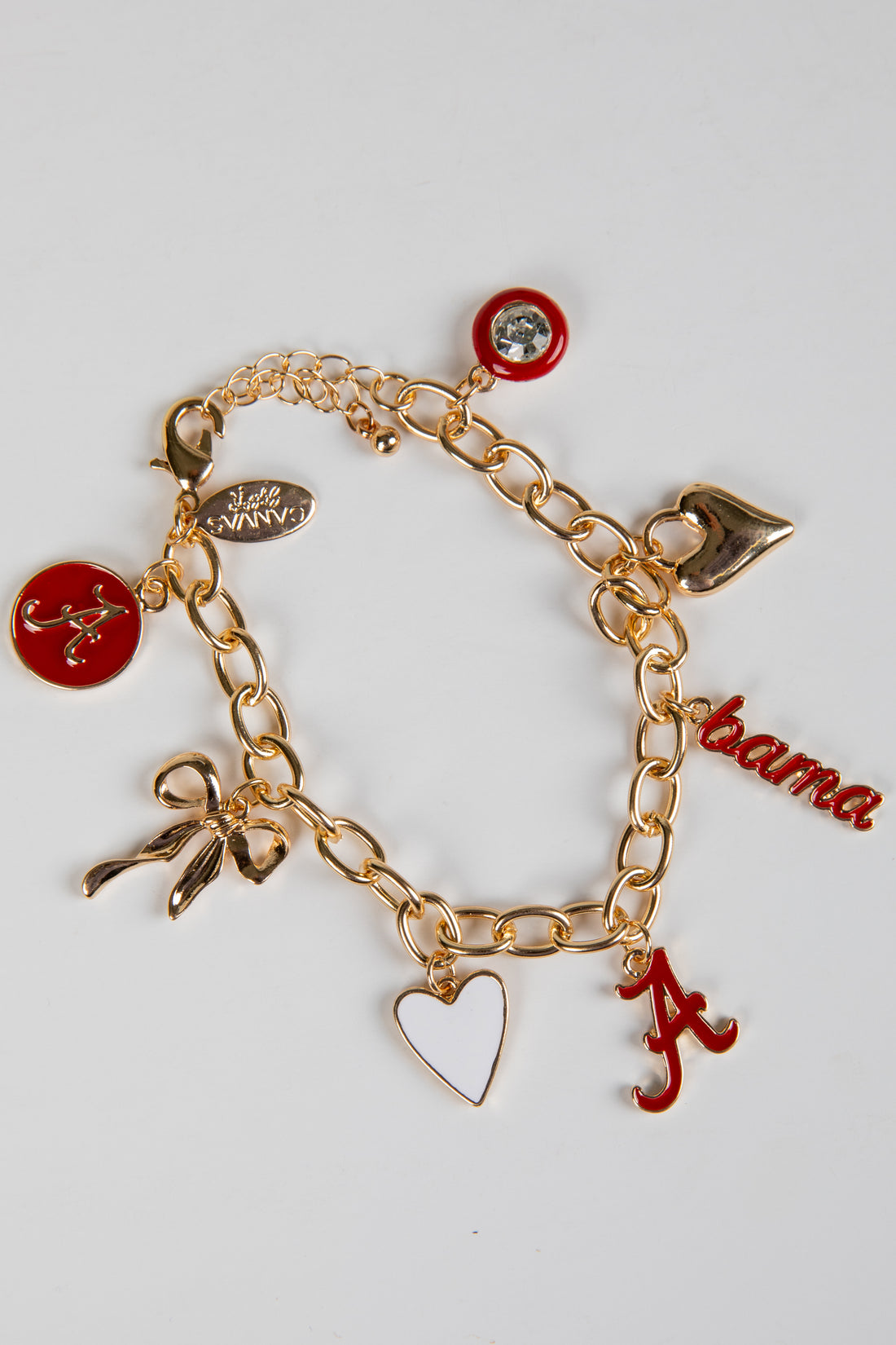 Gold bracelet with various charms including a red &