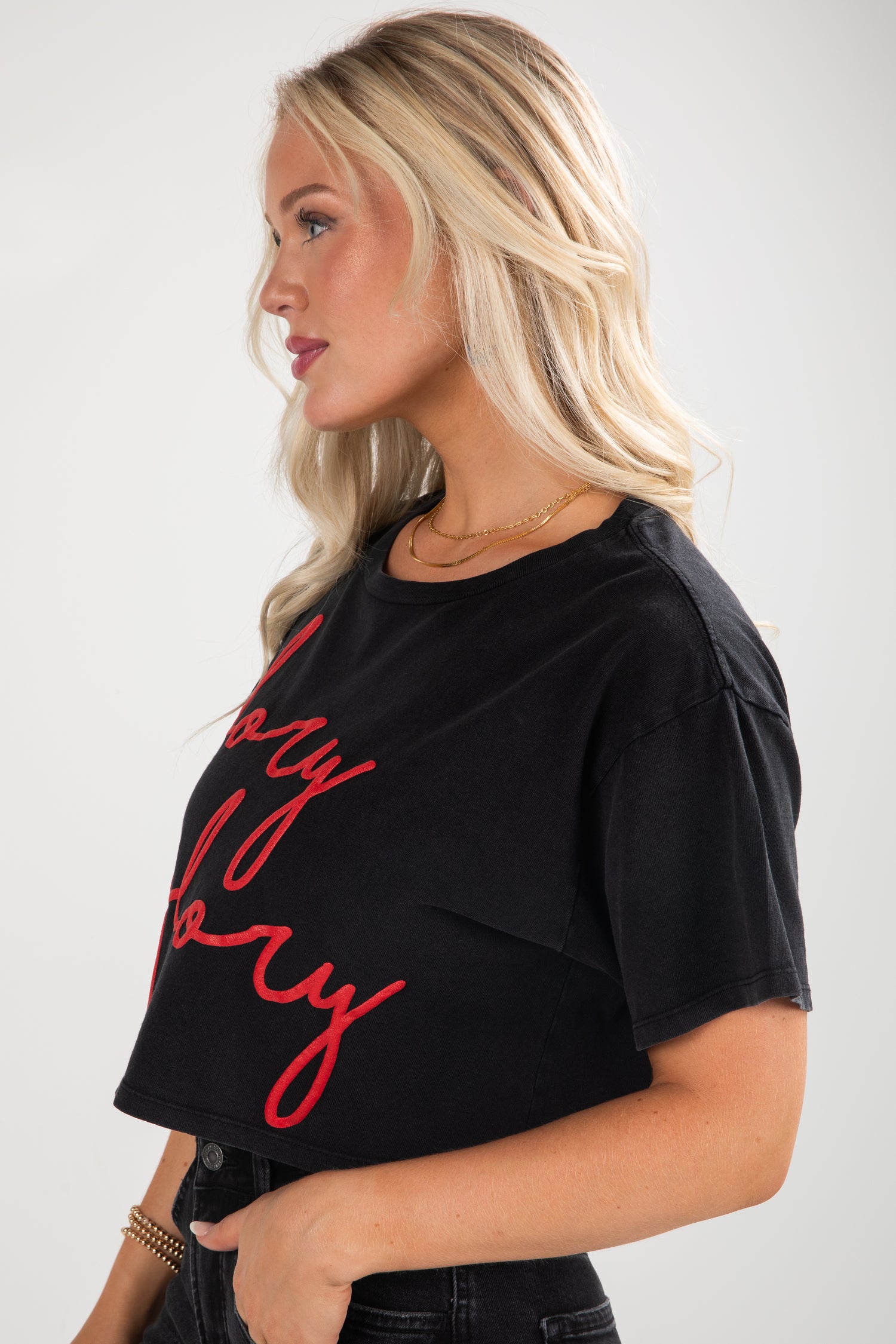 Woman wearing a black t-shirt with red text on a white background