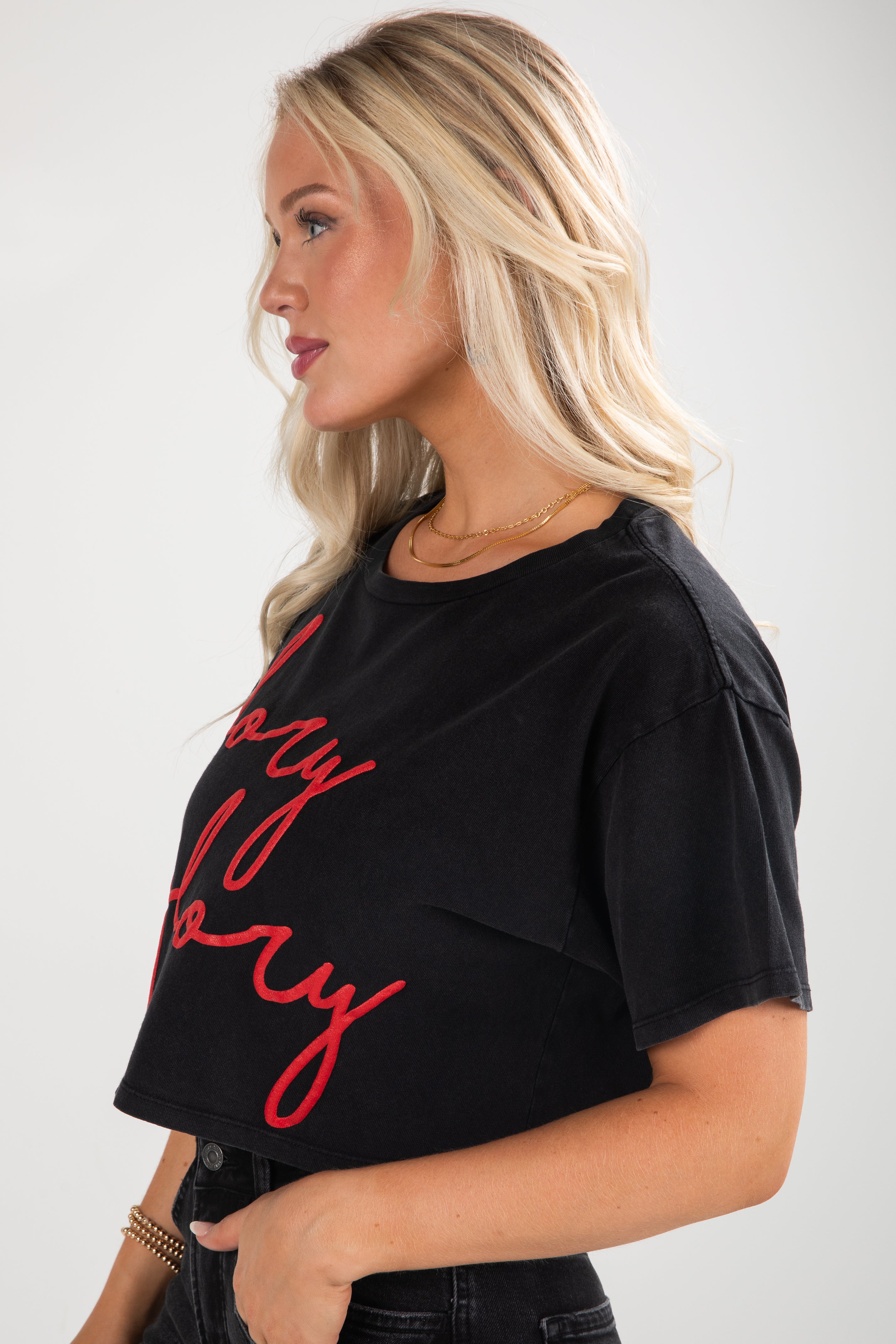 Woman wearing a black t-shirt with red text on a white background