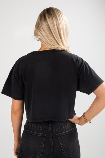 Person wearing a black t-shirt and black pants on a white background