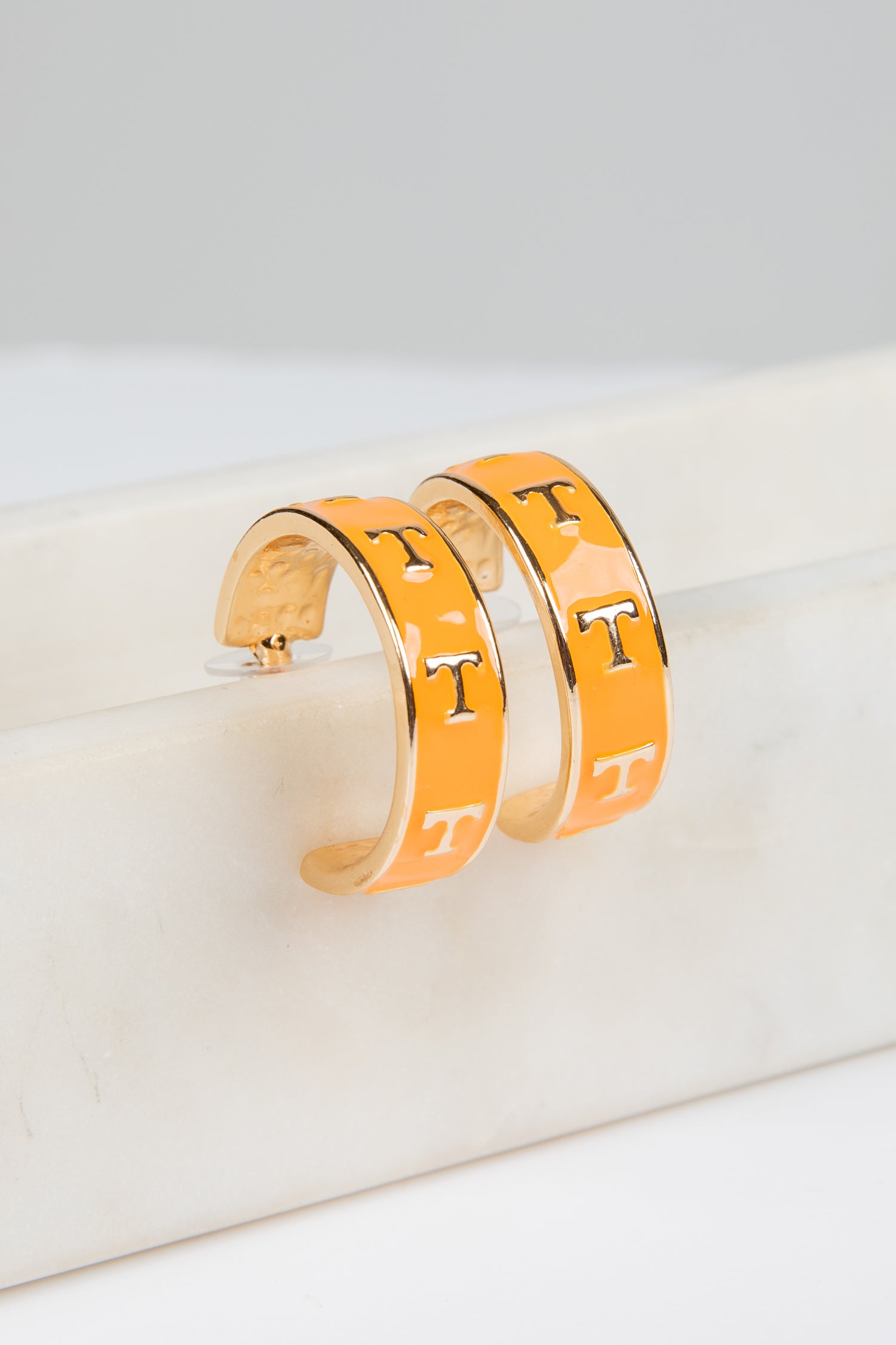 Pair of gold hoop earrings with &