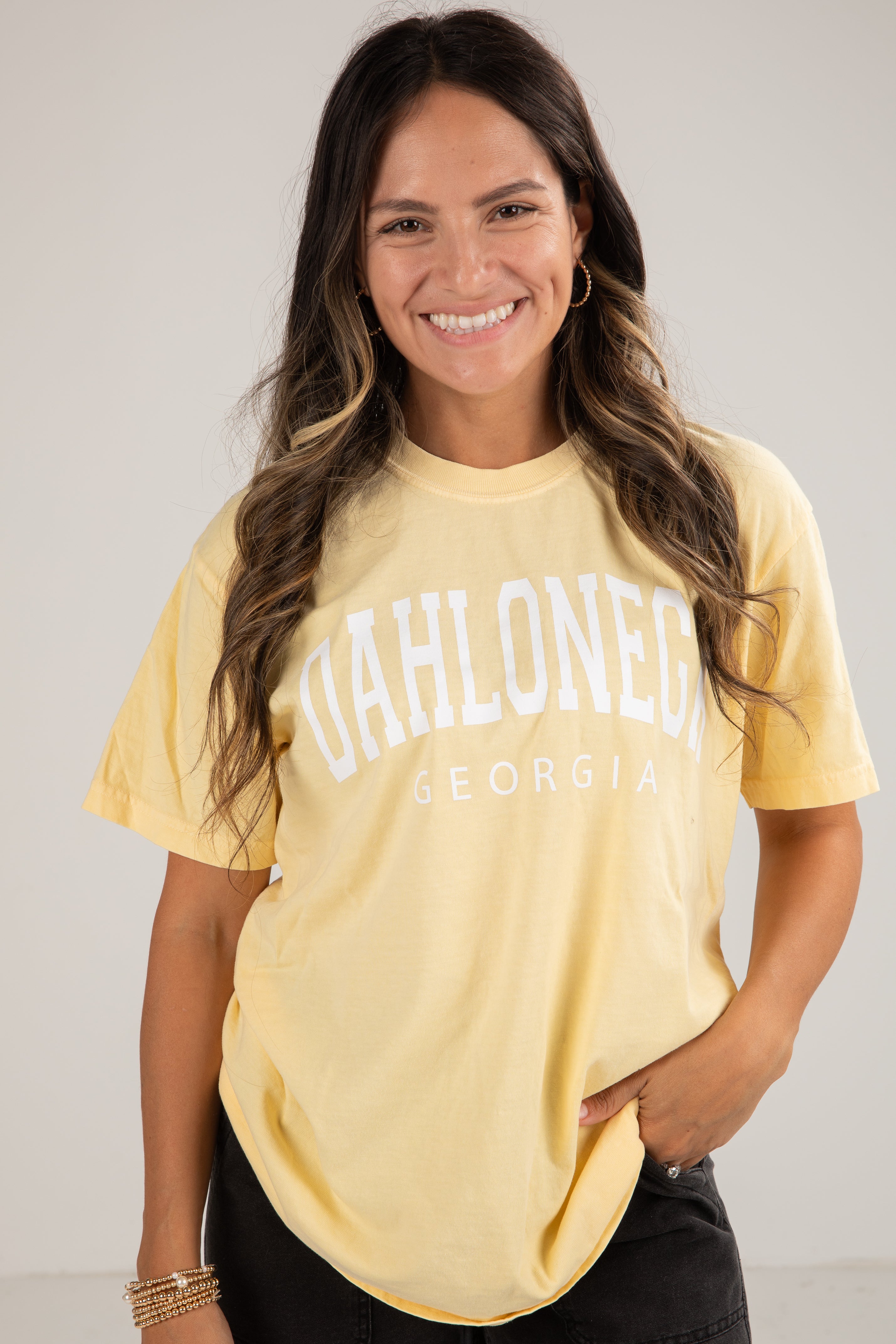 Woman wearing a yellow t-shirt with &