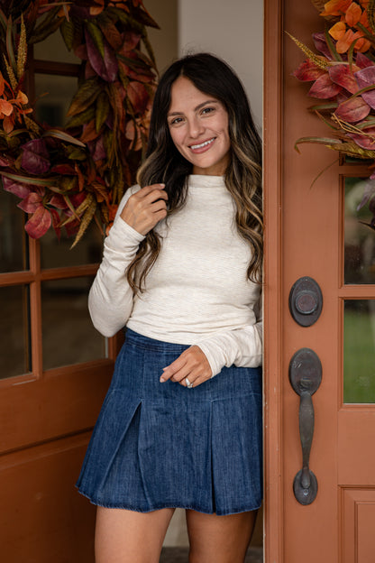 Woman standing in front of a door with autumn decorations