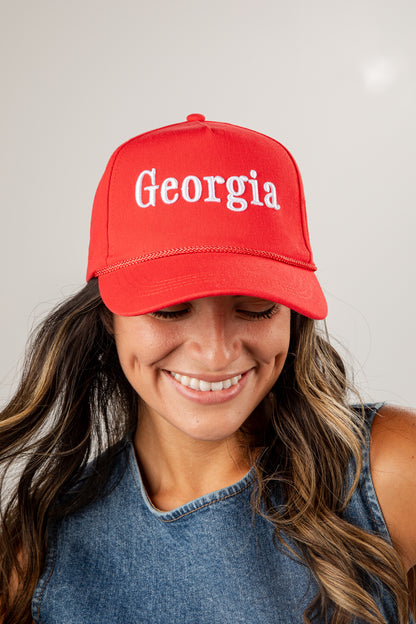 Person wearing a red cap with &