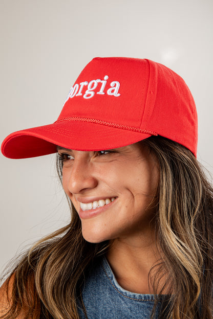 Person wearing a red cap with &