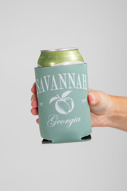 Hand holding a can with a &