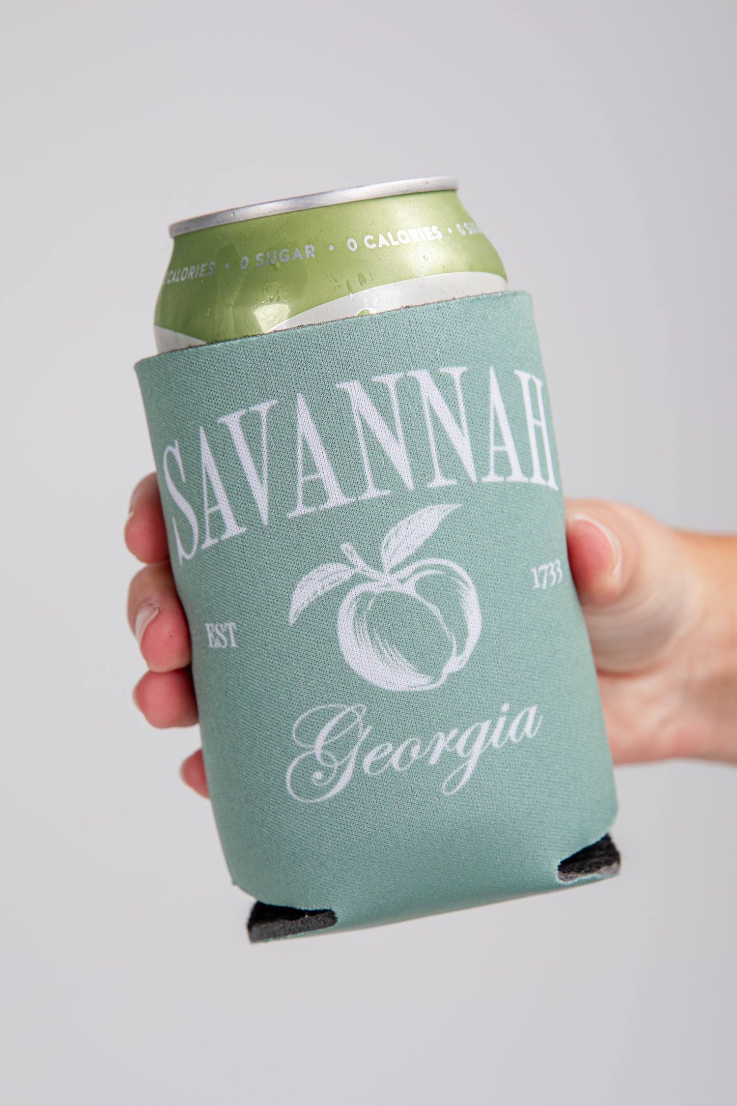 Can with a green sleeve displaying &