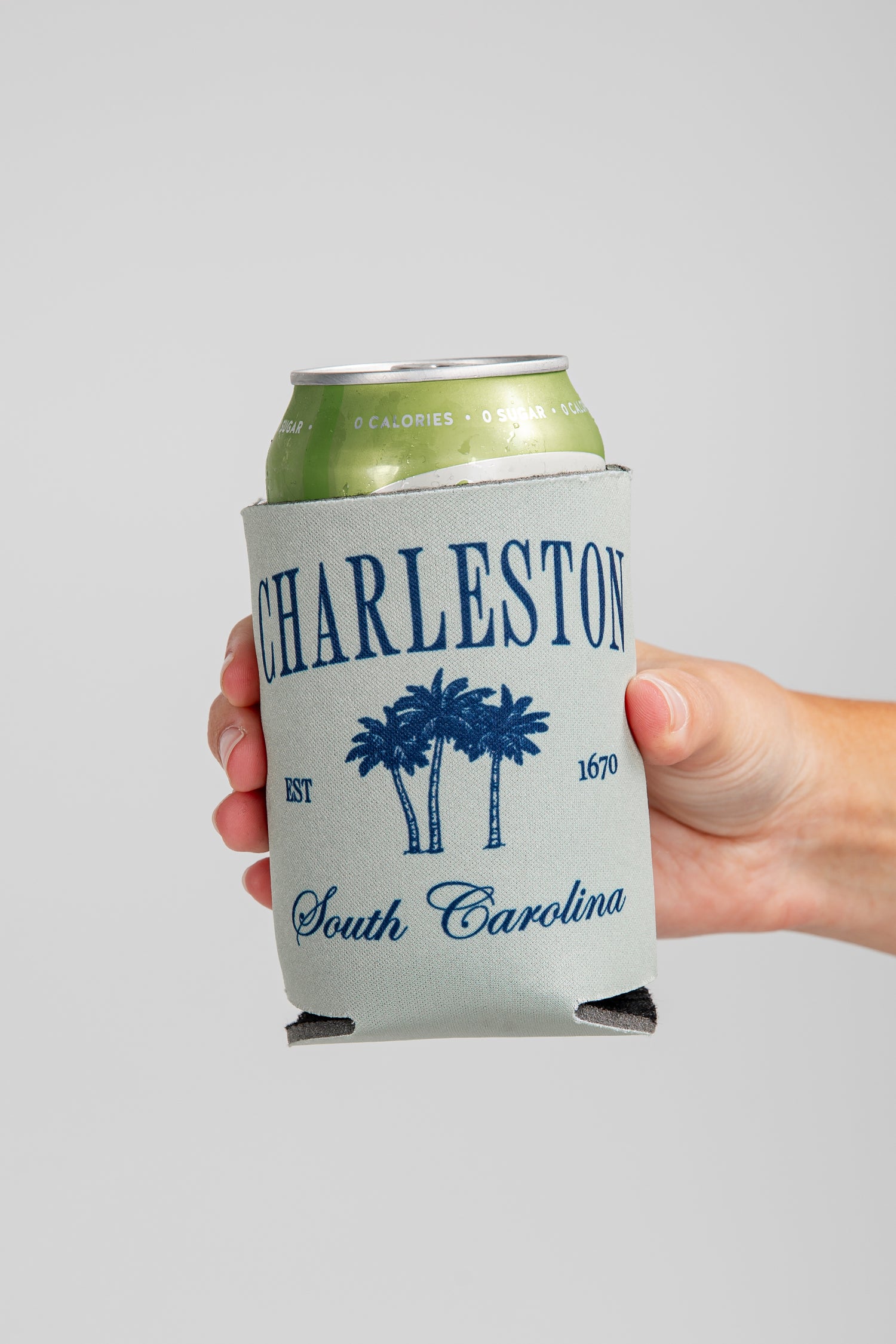 Hand holding a can with a &