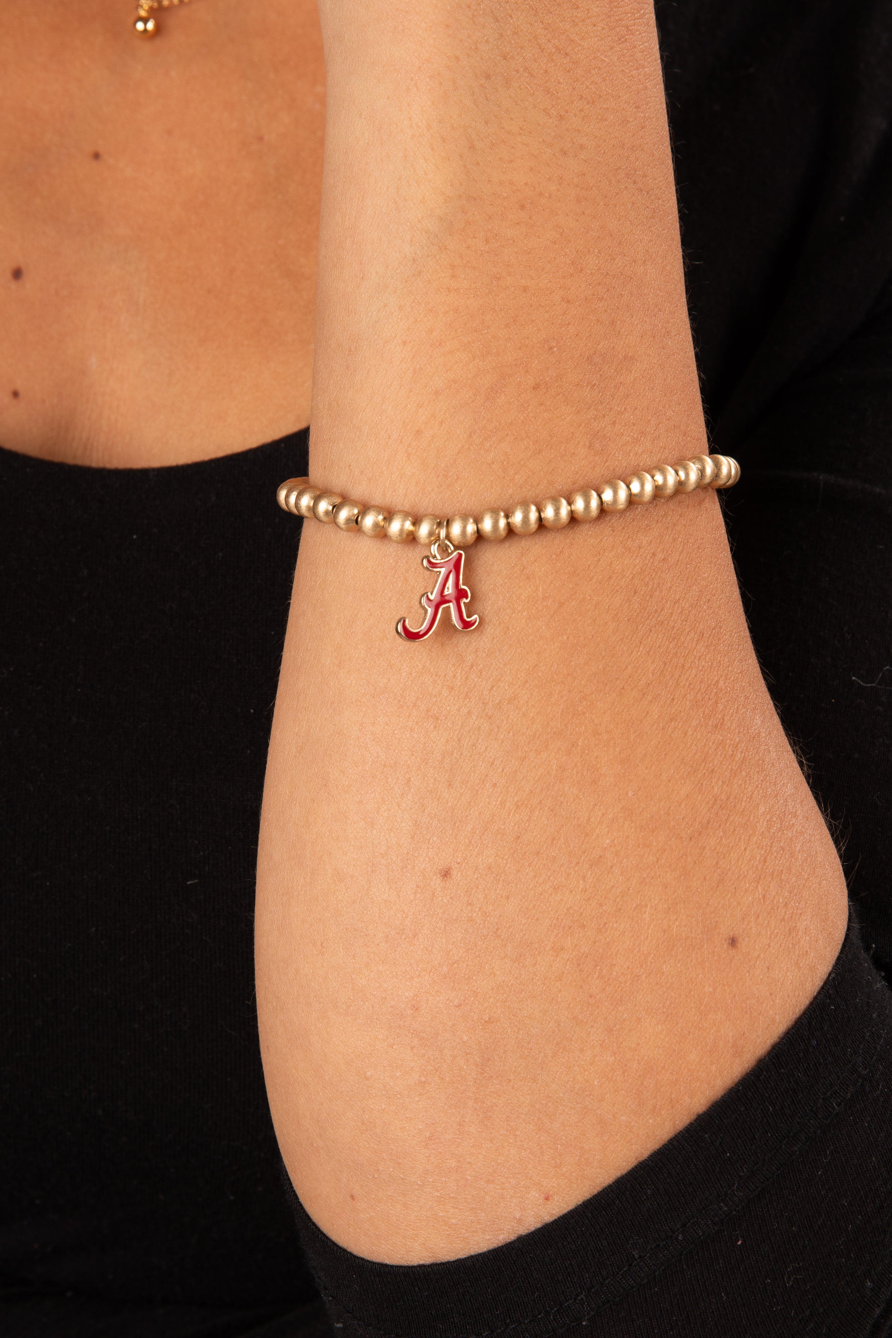 Gold bracelet with a red &