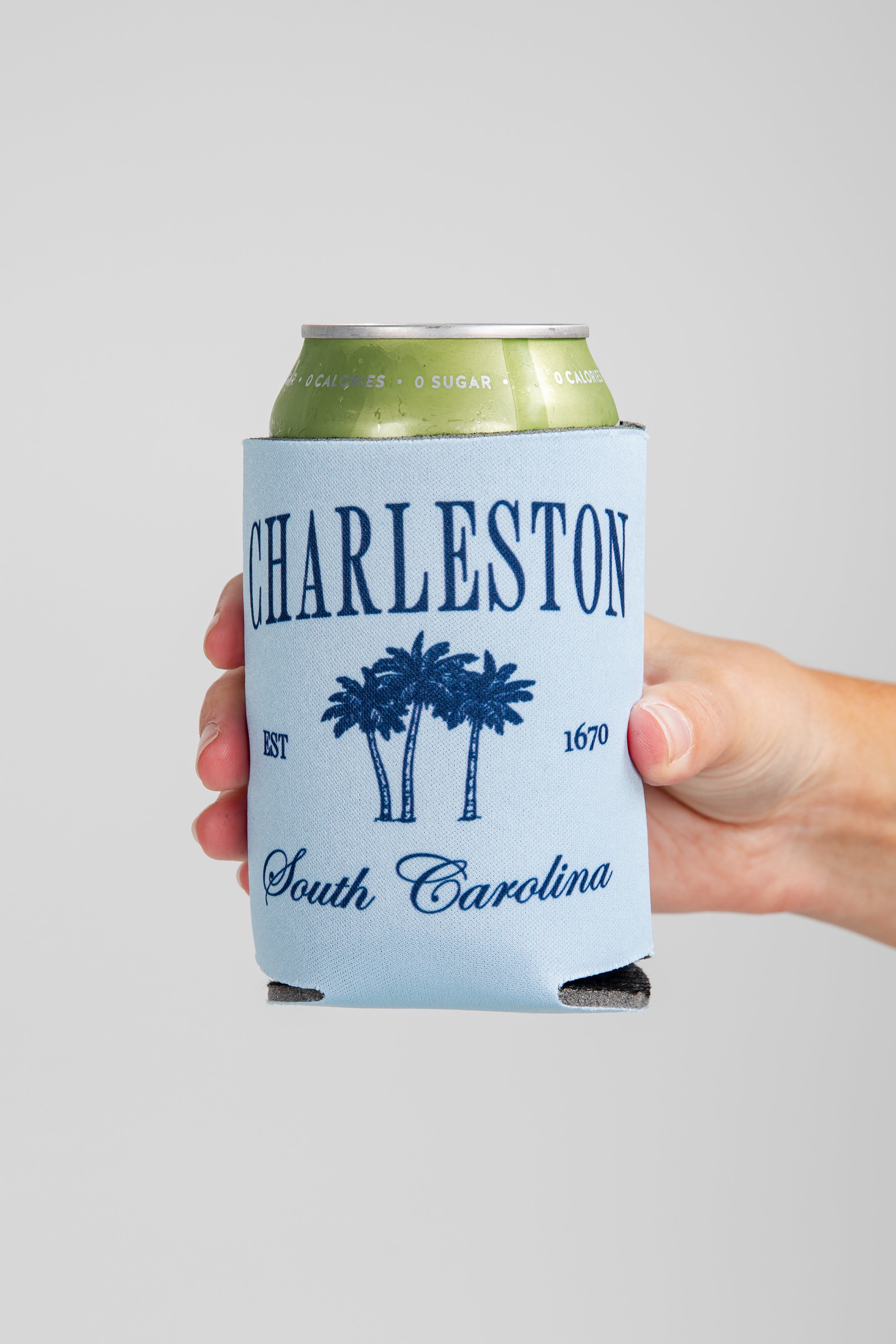 Hand holding a can with &