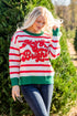 Woman wearing a festive sweater in a Christmas tree farm